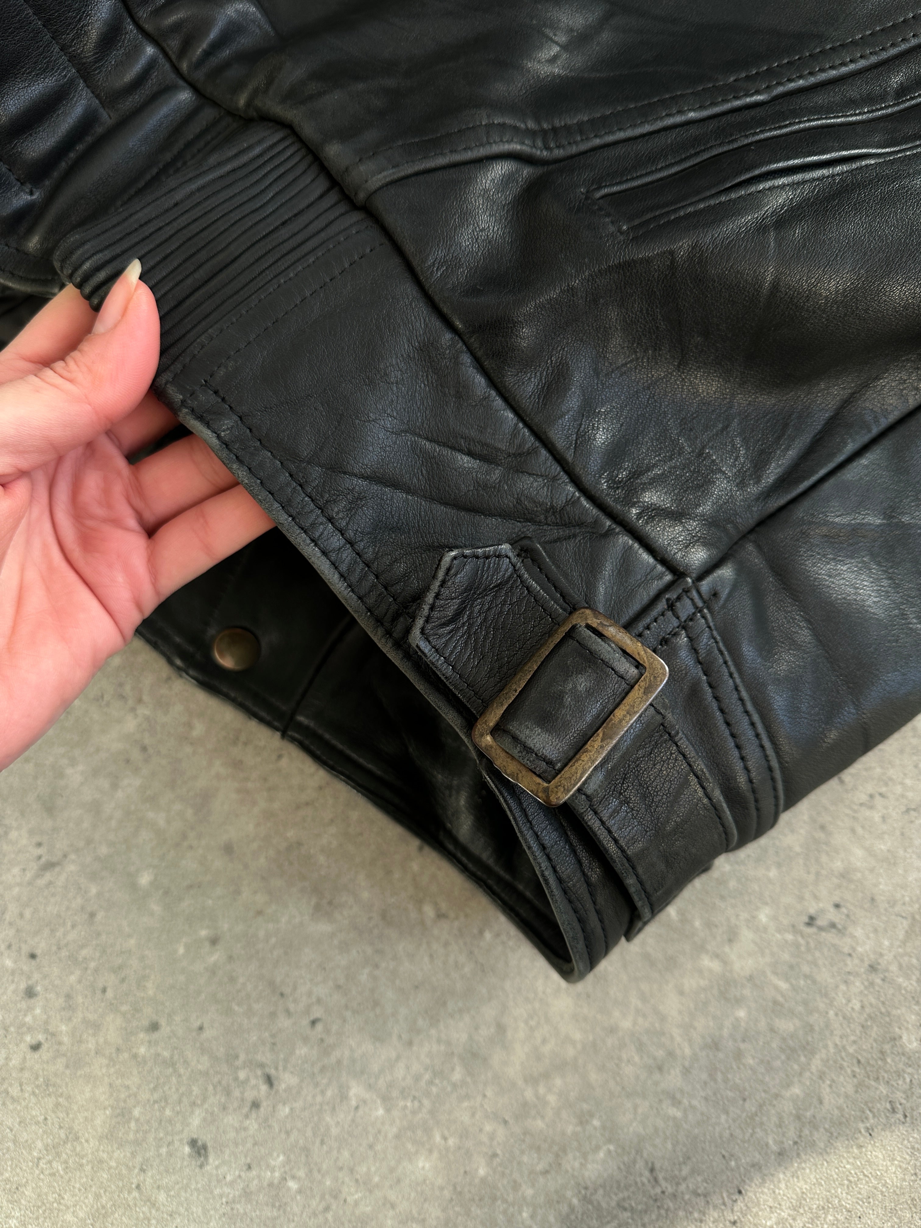 Vintage leather jacket in XL size, showcasing classic design with worn leather texture and stylish collar detail.