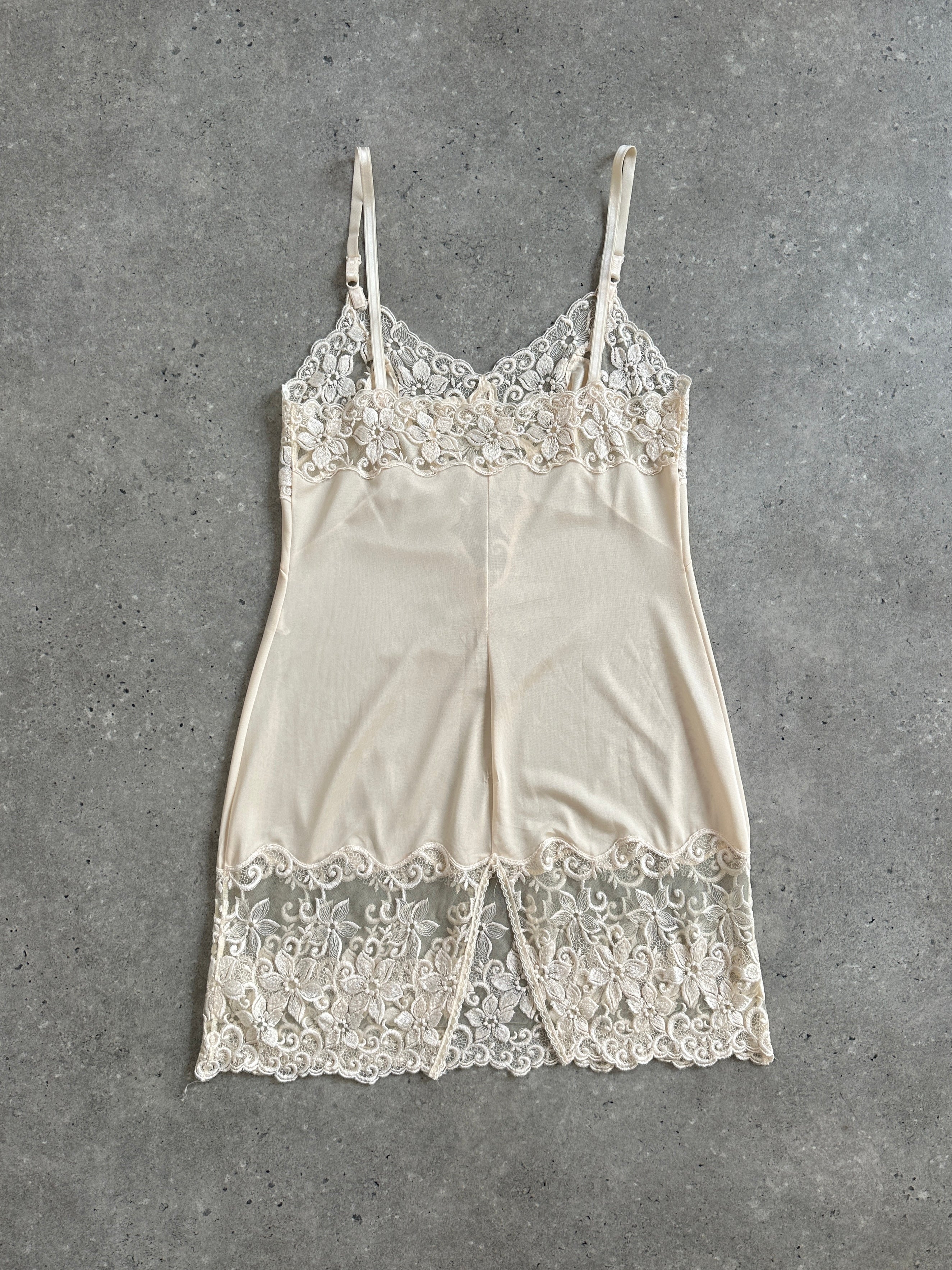 Vintage 1990s lace sheer mini slip dress in XS/S, featuring delicate fabric and a classic 90s style, ideal for vintage fashion.