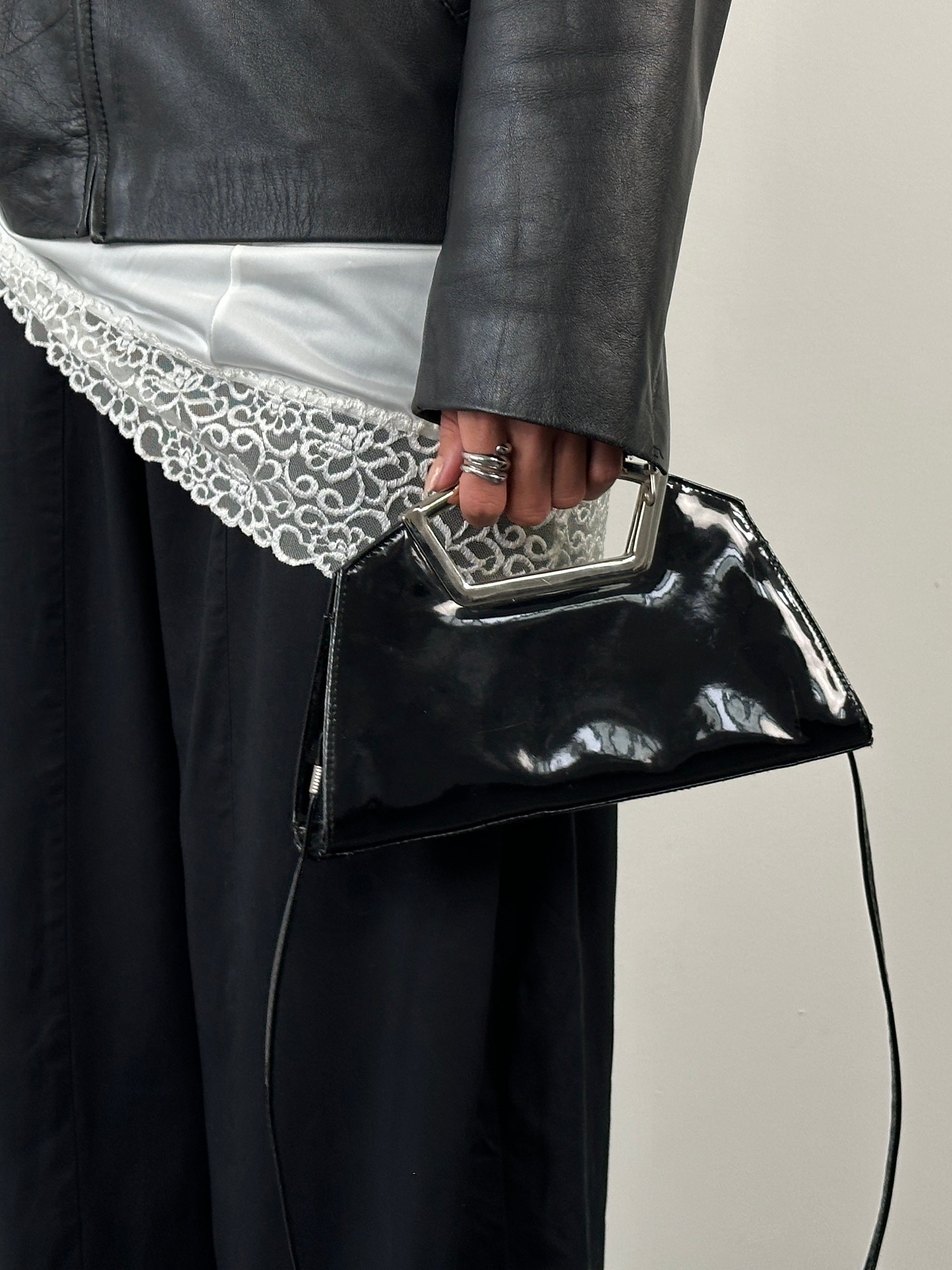 Vintage 2000s patent vinyl chrome crossbody clutch bag with sleek design and metallic finish.