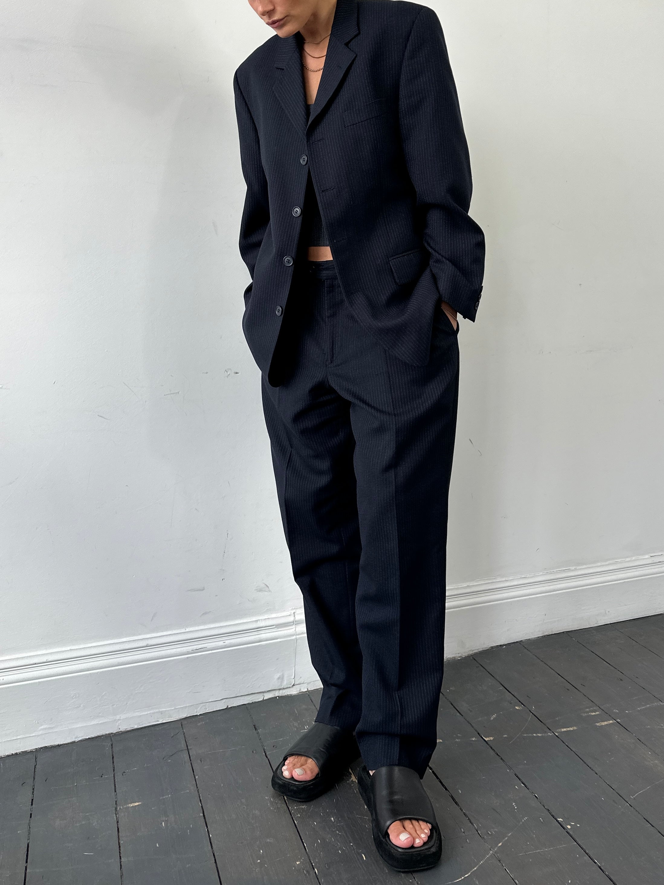 Vintage pinstripe wool single-breasted suit jumpsuit with tailored fit, size 40R/W34, featuring lapel collar and button details.