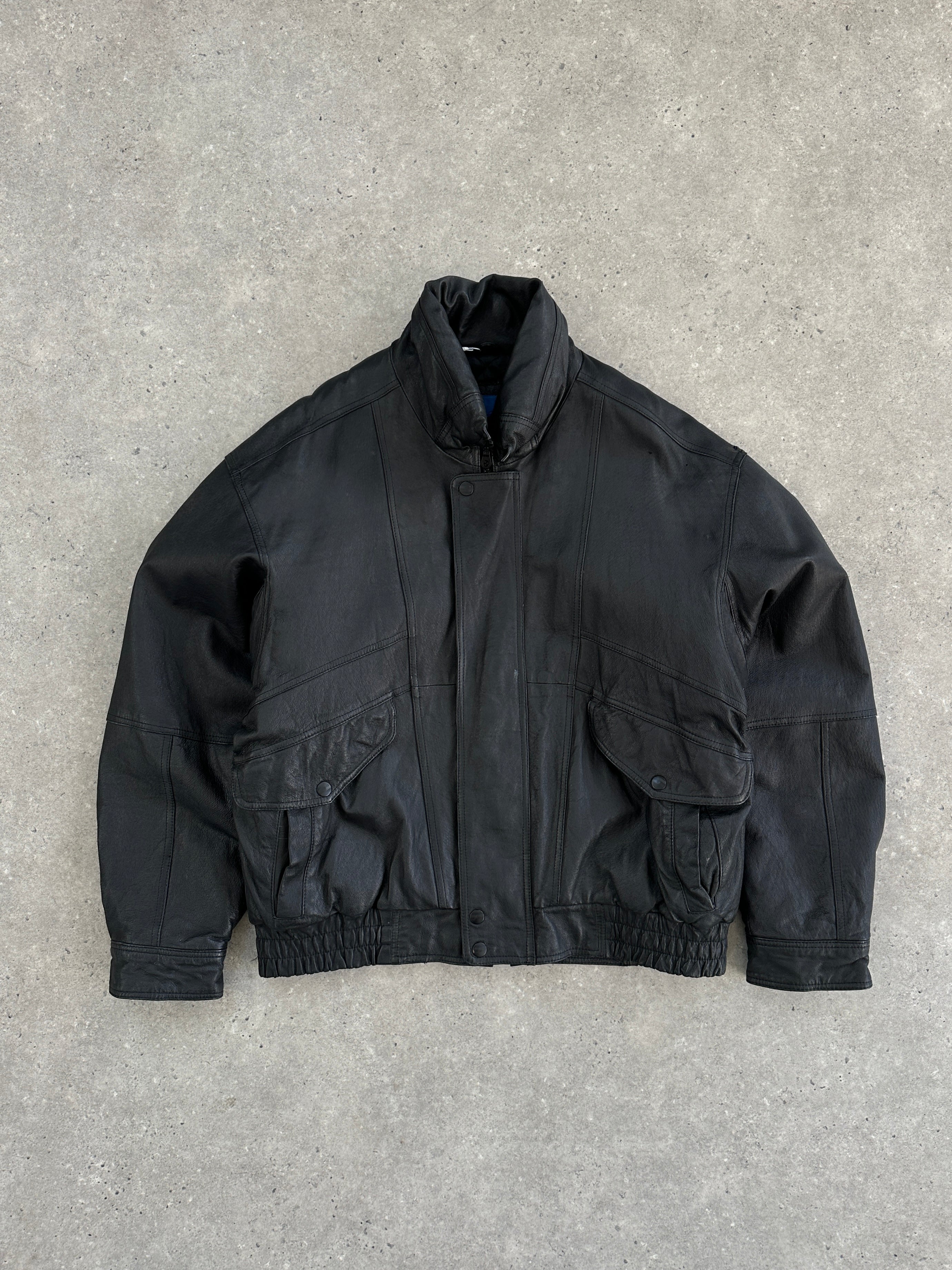 Vintage leather bomber jacket in size large, featuring classic design, ribbed cuffs, and collar on a neutral background.