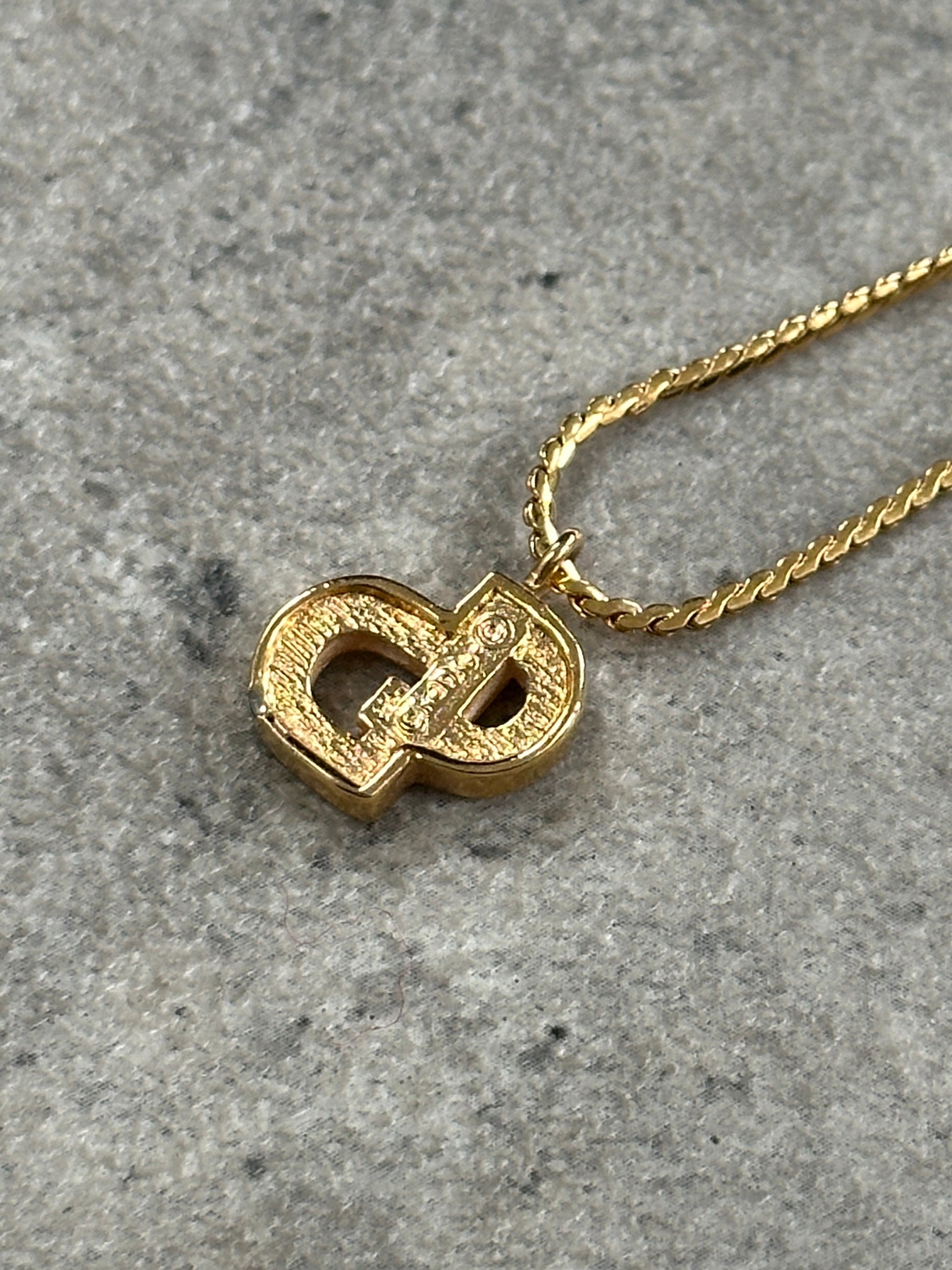 Christian Dior 16-inch gold plated logo pendant necklace with a sleek, elegant design and polished finish.