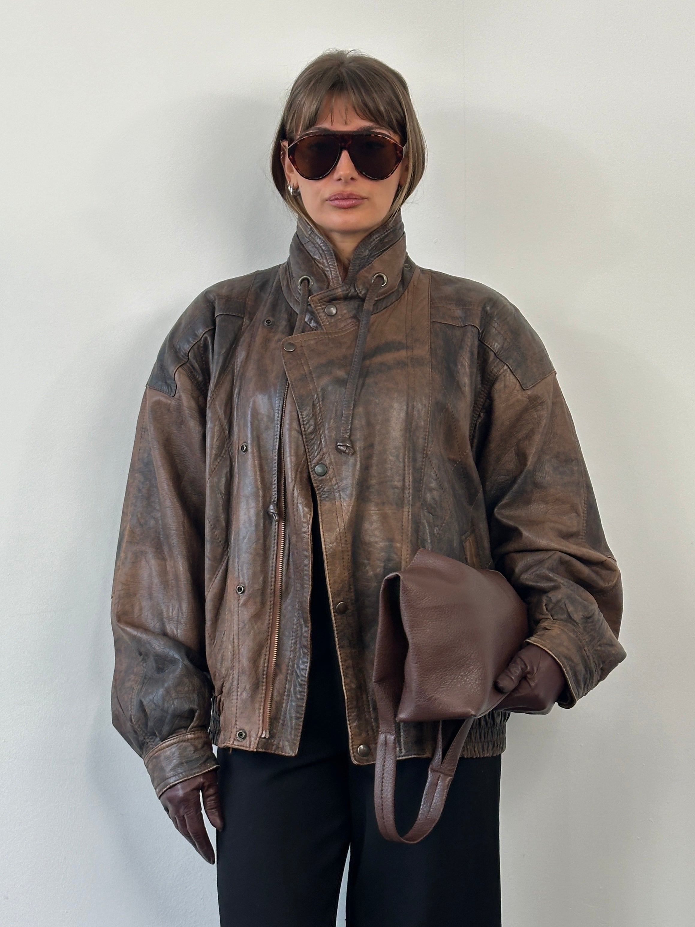 Vintage 1990s high neck leather bomber jacket in aged leather, size XL, featuring classic vintage design with detailed stitching.