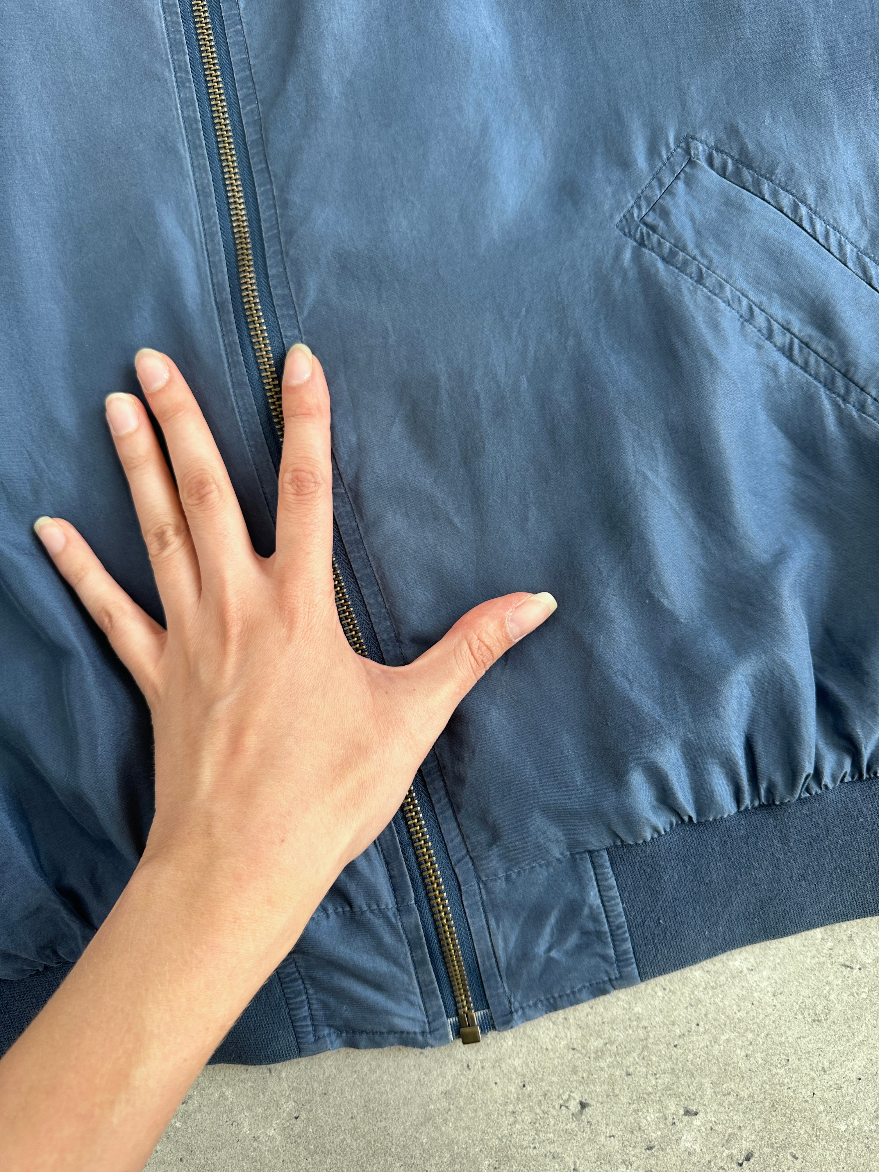 Vintage 90s pure silk bomber jacket in size L, featuring a sleek design and classic style, displayed on a hanger.