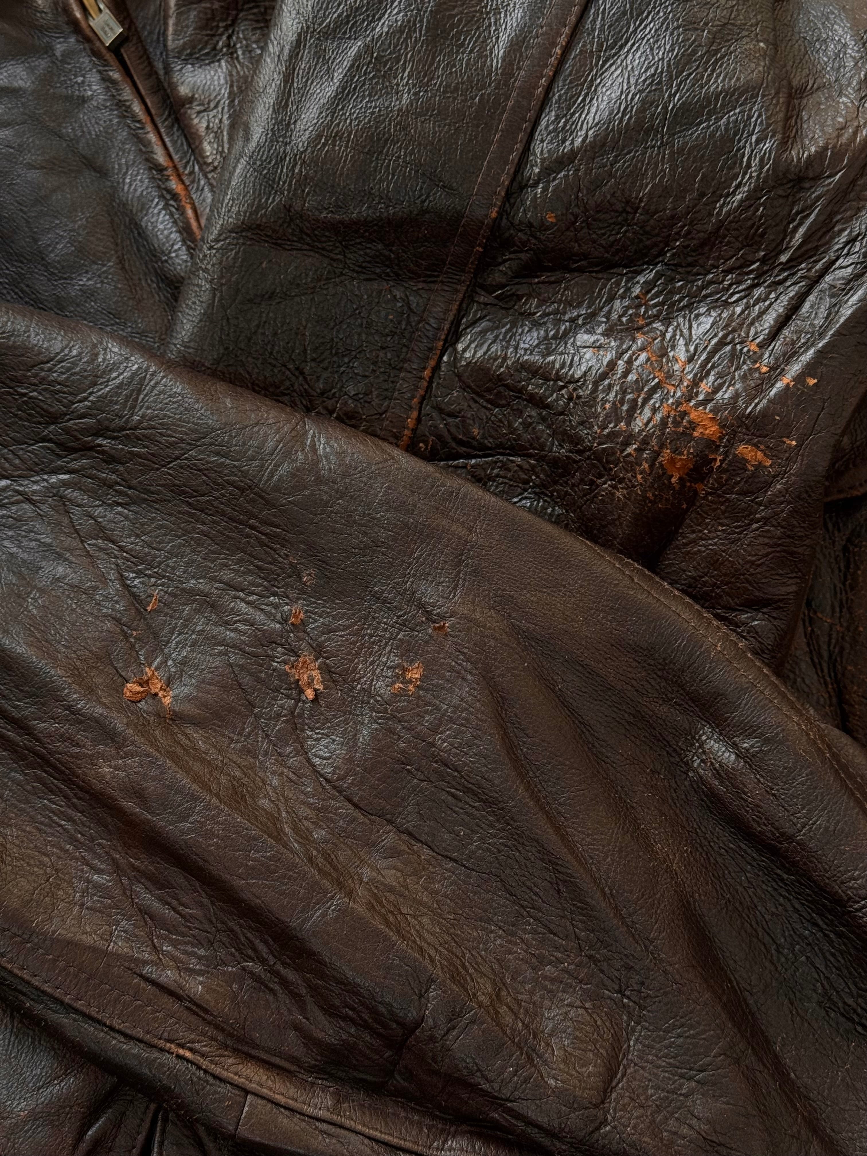 Vintage 1990s distressed leather bomber jacket in XL size, featuring rugged texture and classic fit.