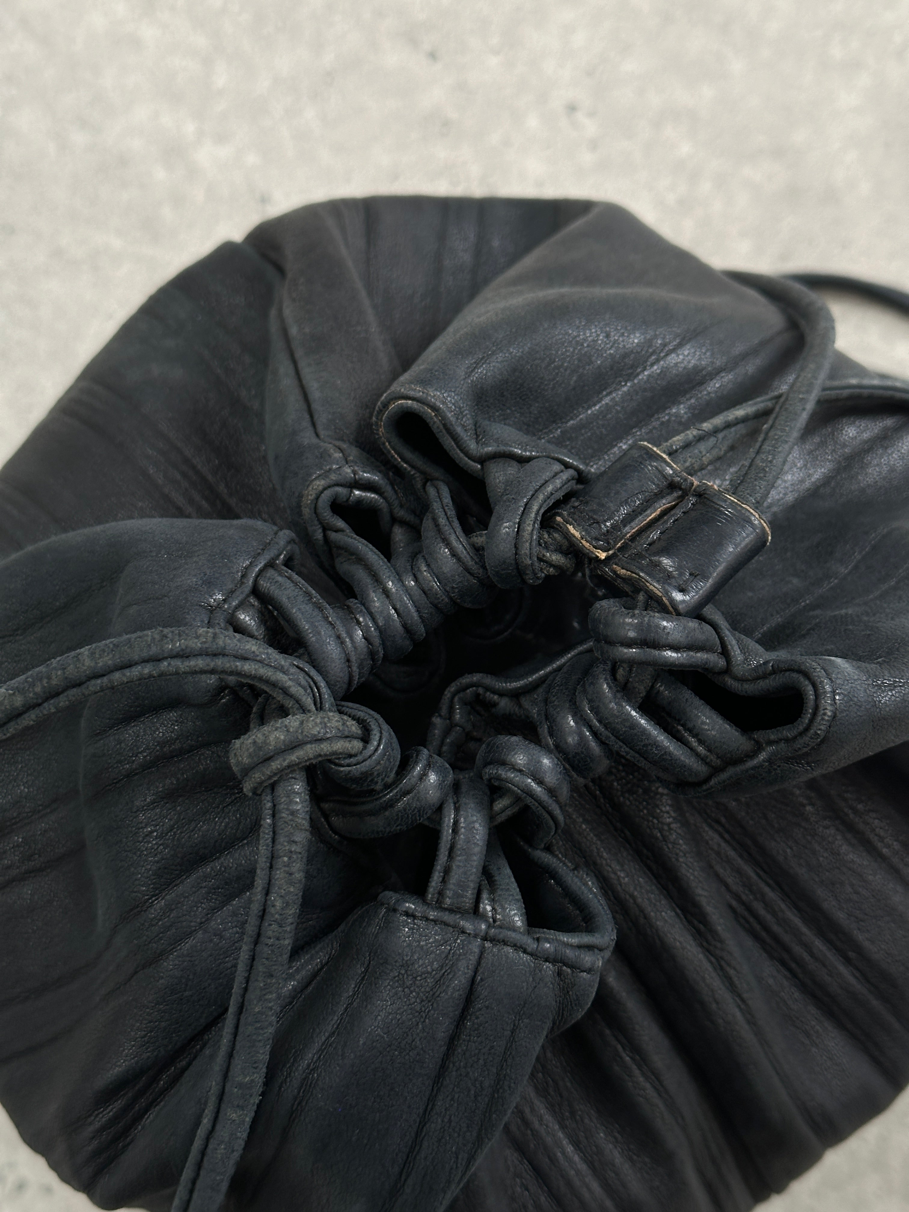 Giorgio Armani Le Collezioni leather rucksack bag with adjustable straps and sleek design, displayed on a plain background.