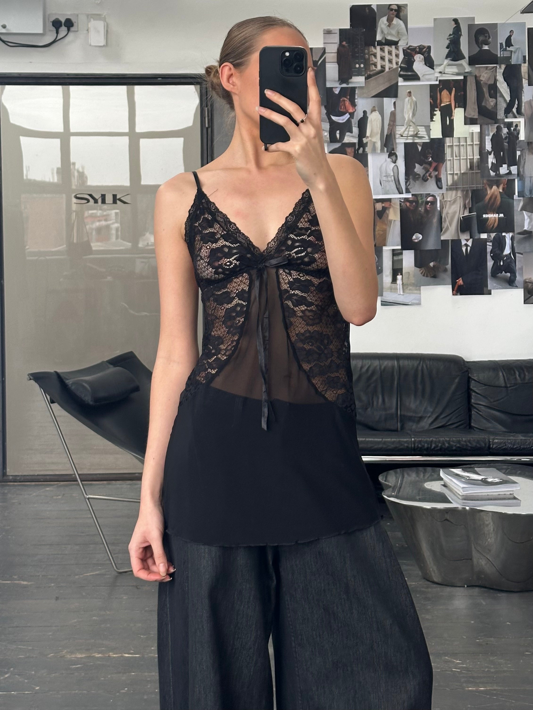 Vintage 1990s sheer lace top in size small, featuring delicate floral lace and a lightweight, feminine design.