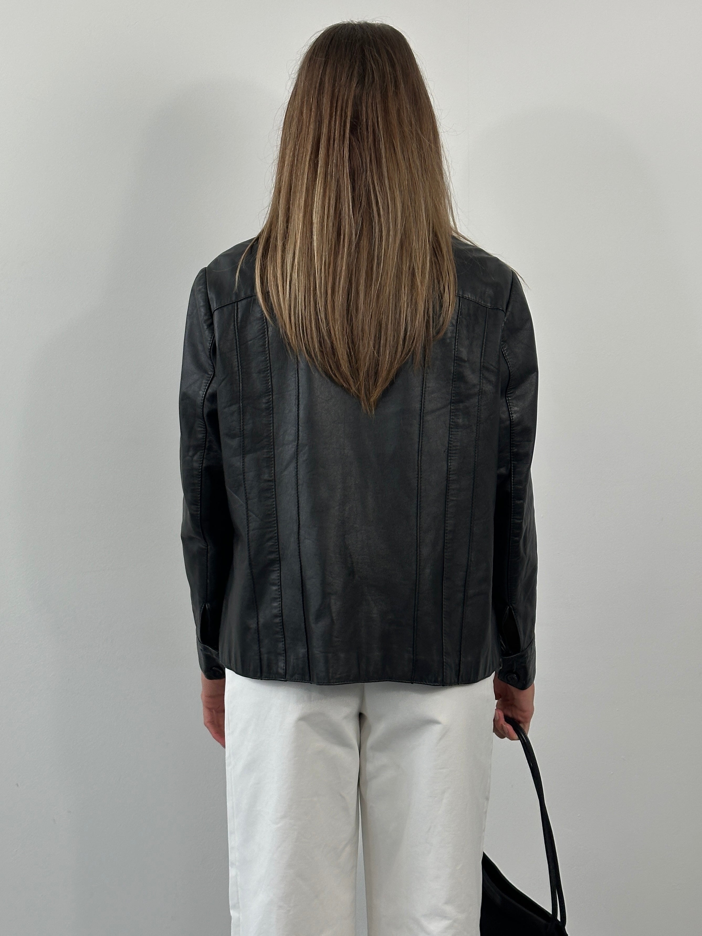Vintage 1990s dagger collar leather jacket in medium size, featuring classic black leather and bold design details.