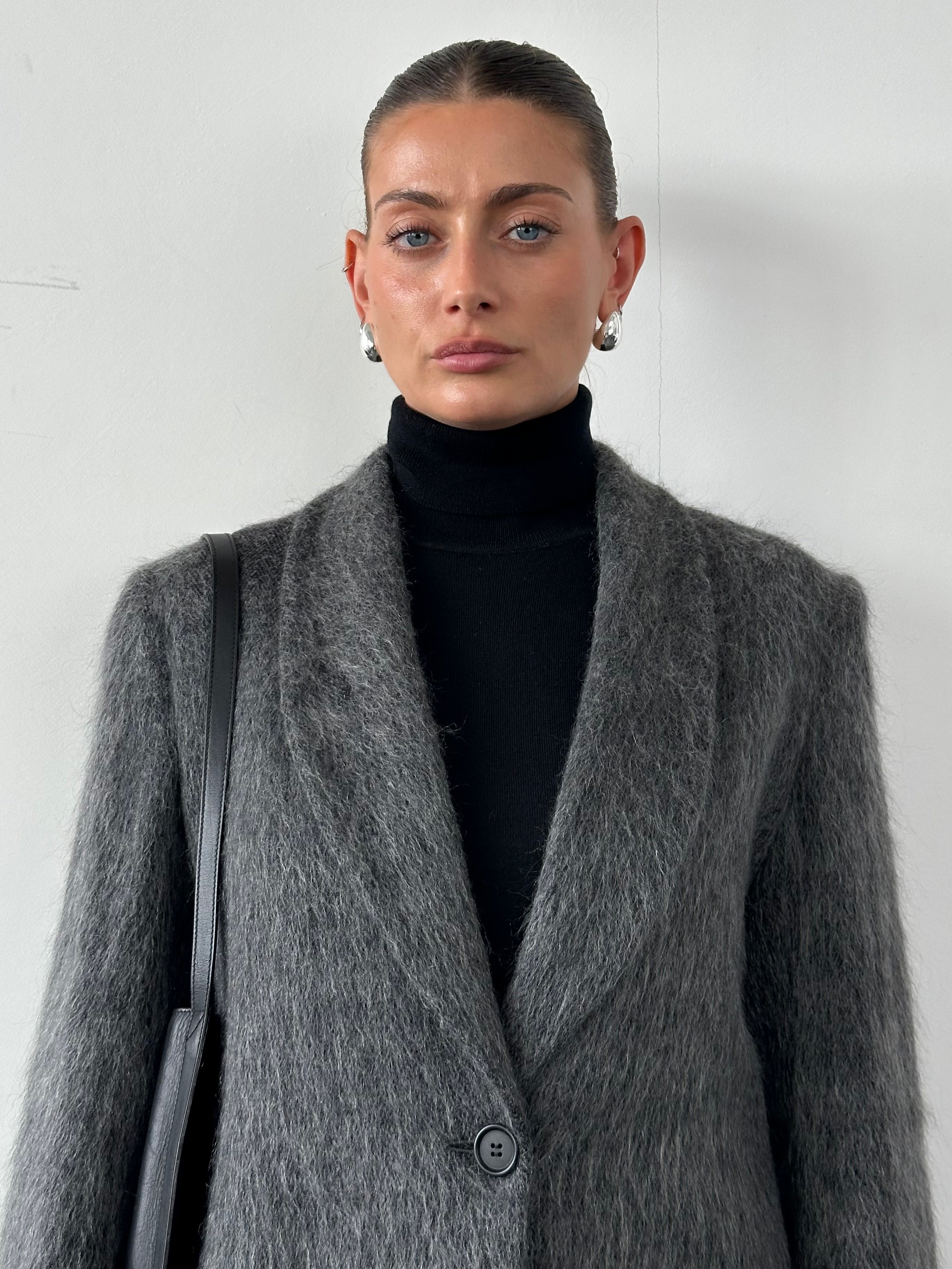Emporio Armani fuzzy wool mohair single-breasted coat in size M displayed on a hanger, showcasing its soft texture and classic design.