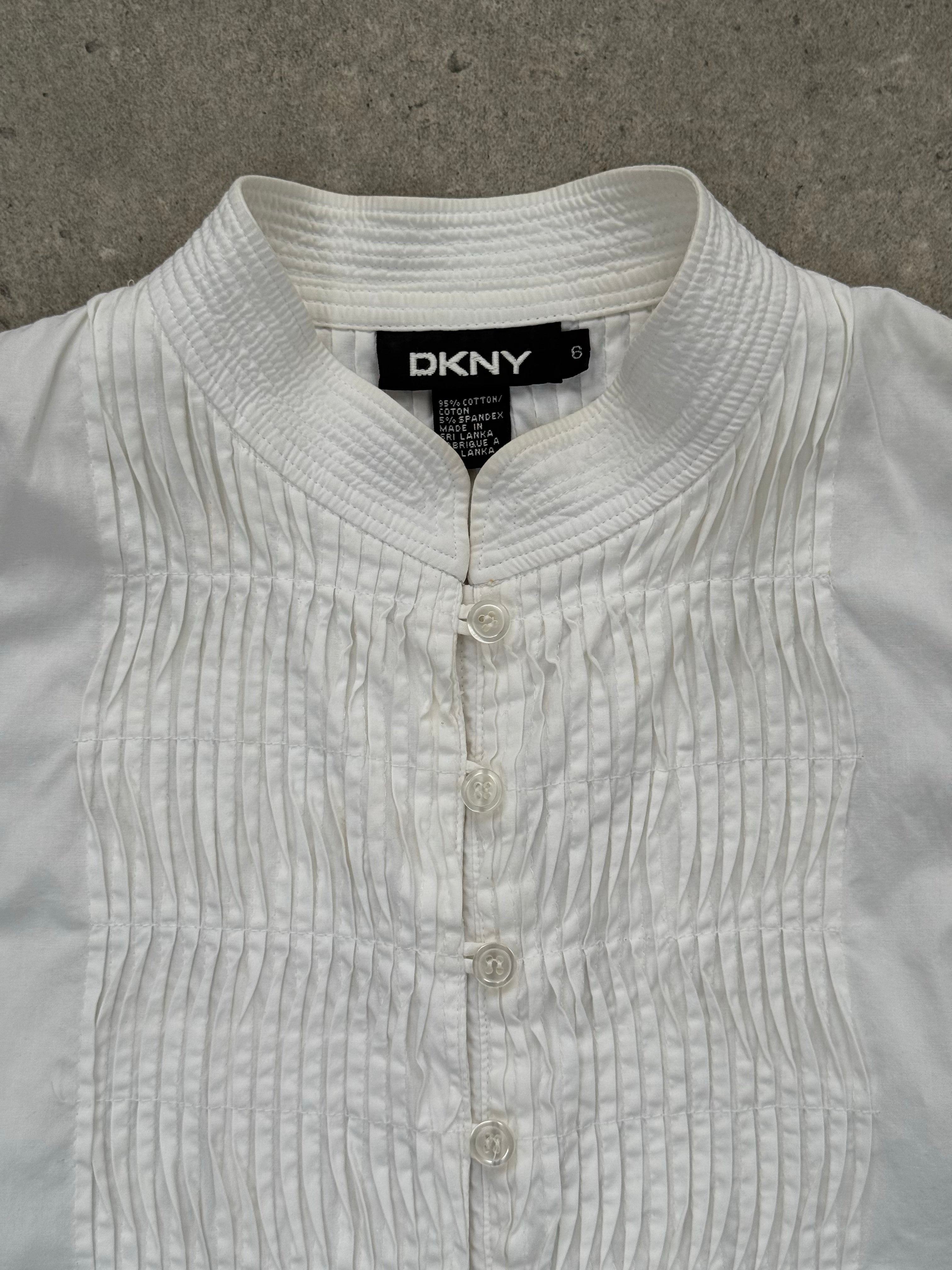 DKNY 2000s pleated cotton sleeveless top in white, featuring a fitted bodice and pleated design, size M.