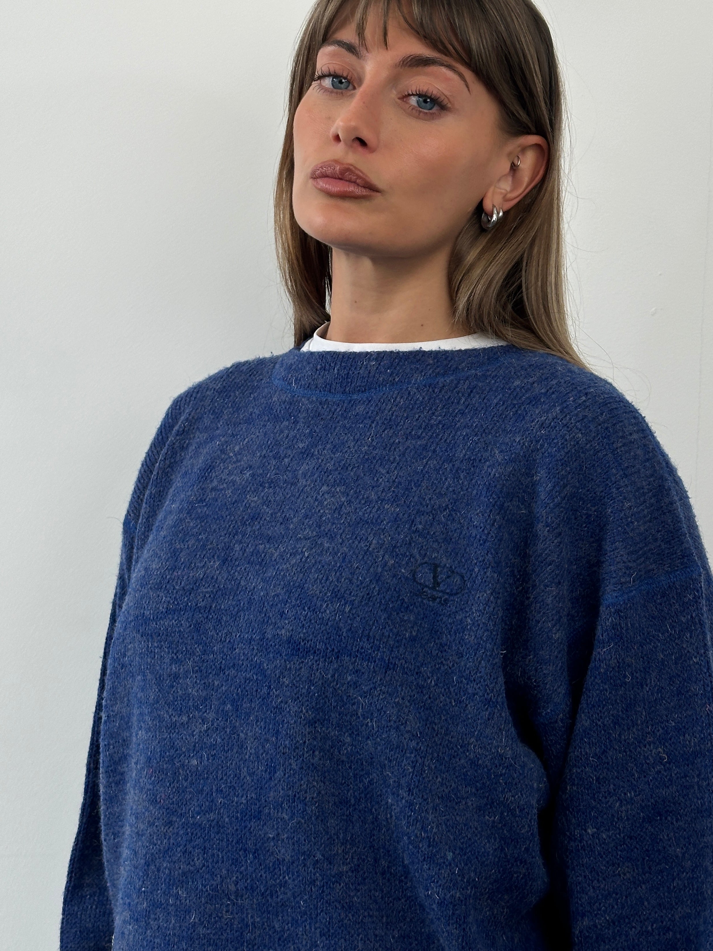 Valentino 1990s wool cropped logo knitted jumper displayed on a hanger, featuring a bold Valentino logo knit pattern.
