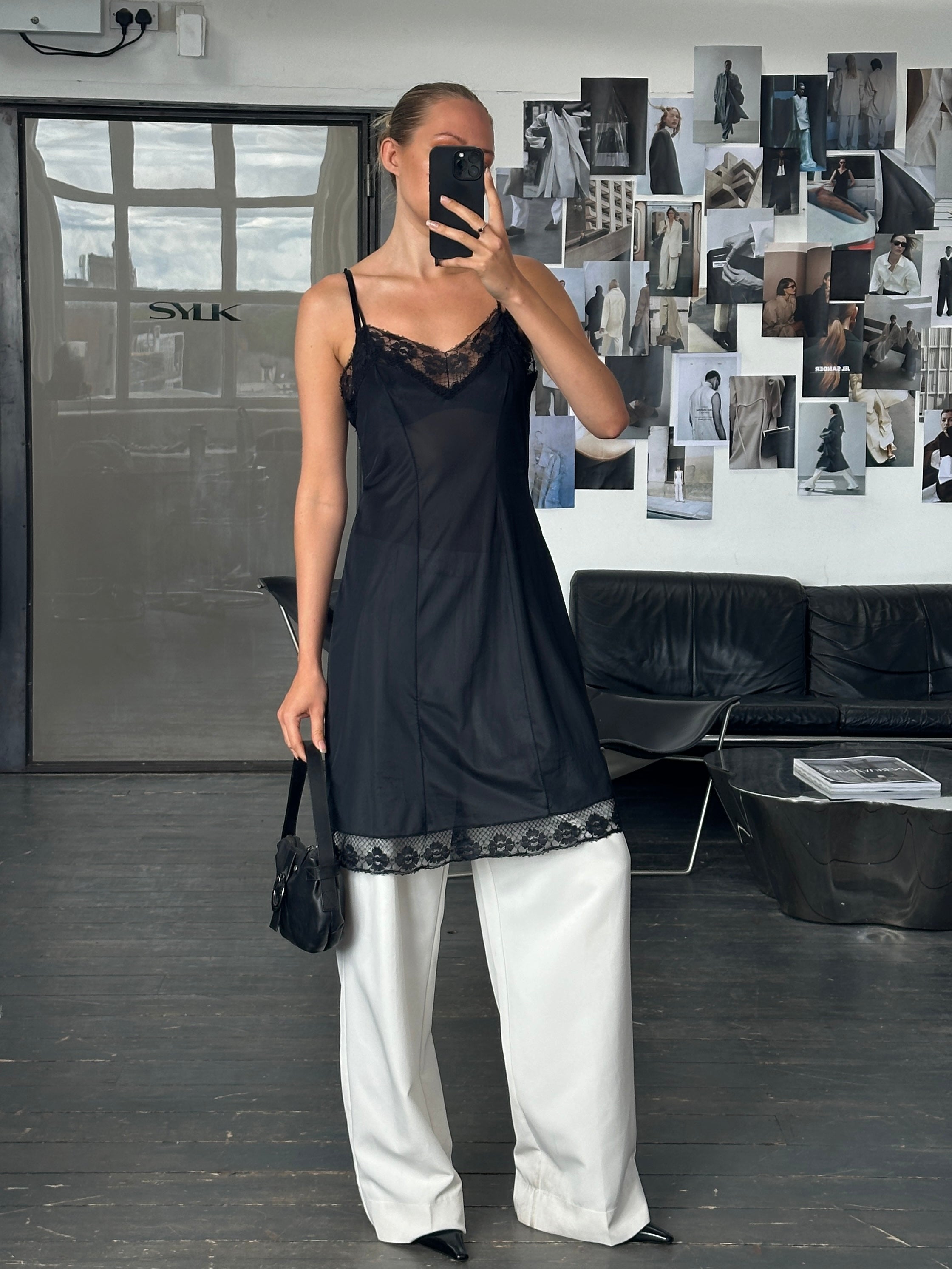 Vintage 1980s lace semi-sheer slip dress in size M featuring delicate lace fabric and vintage style, displayed on a hanger.