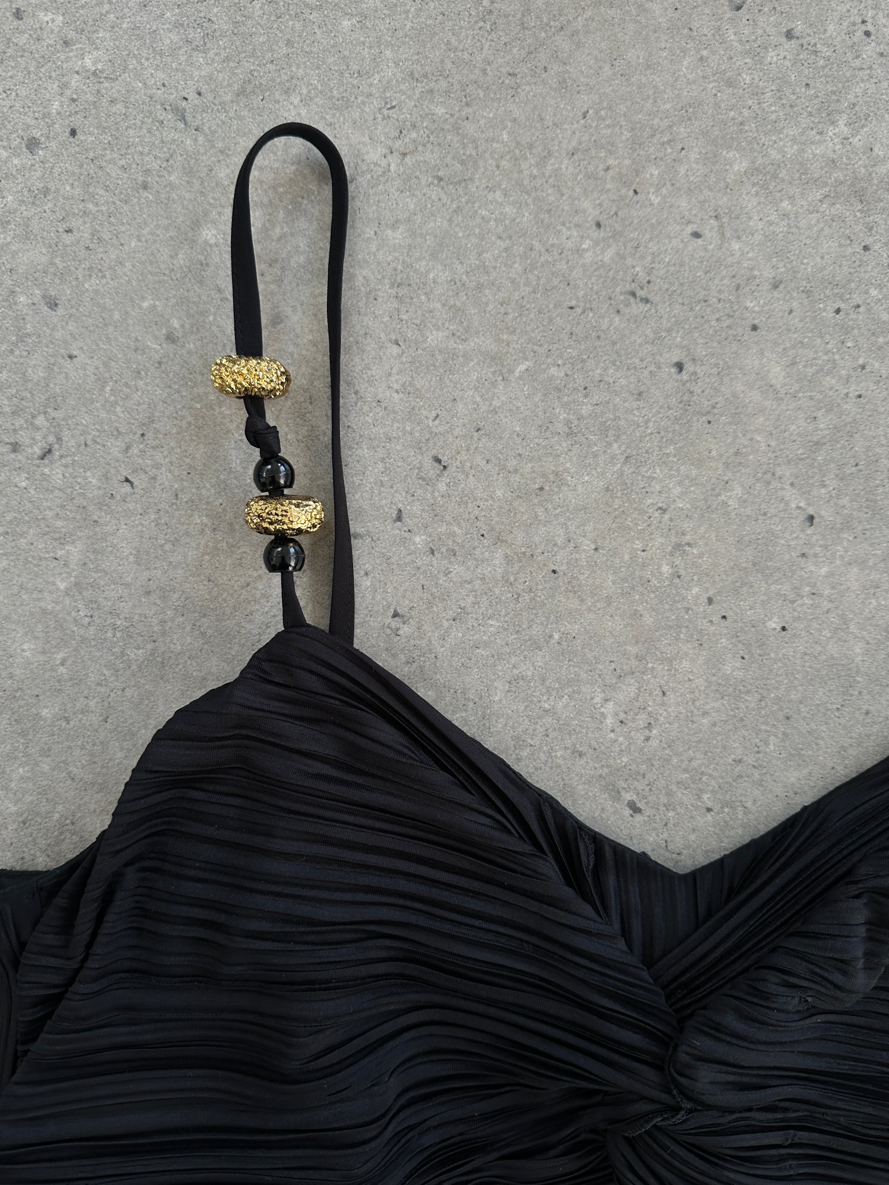 Vintage brand vintage plisse maxi dress in M/L size with flowing fabric and retro style, displayed on a hanger.