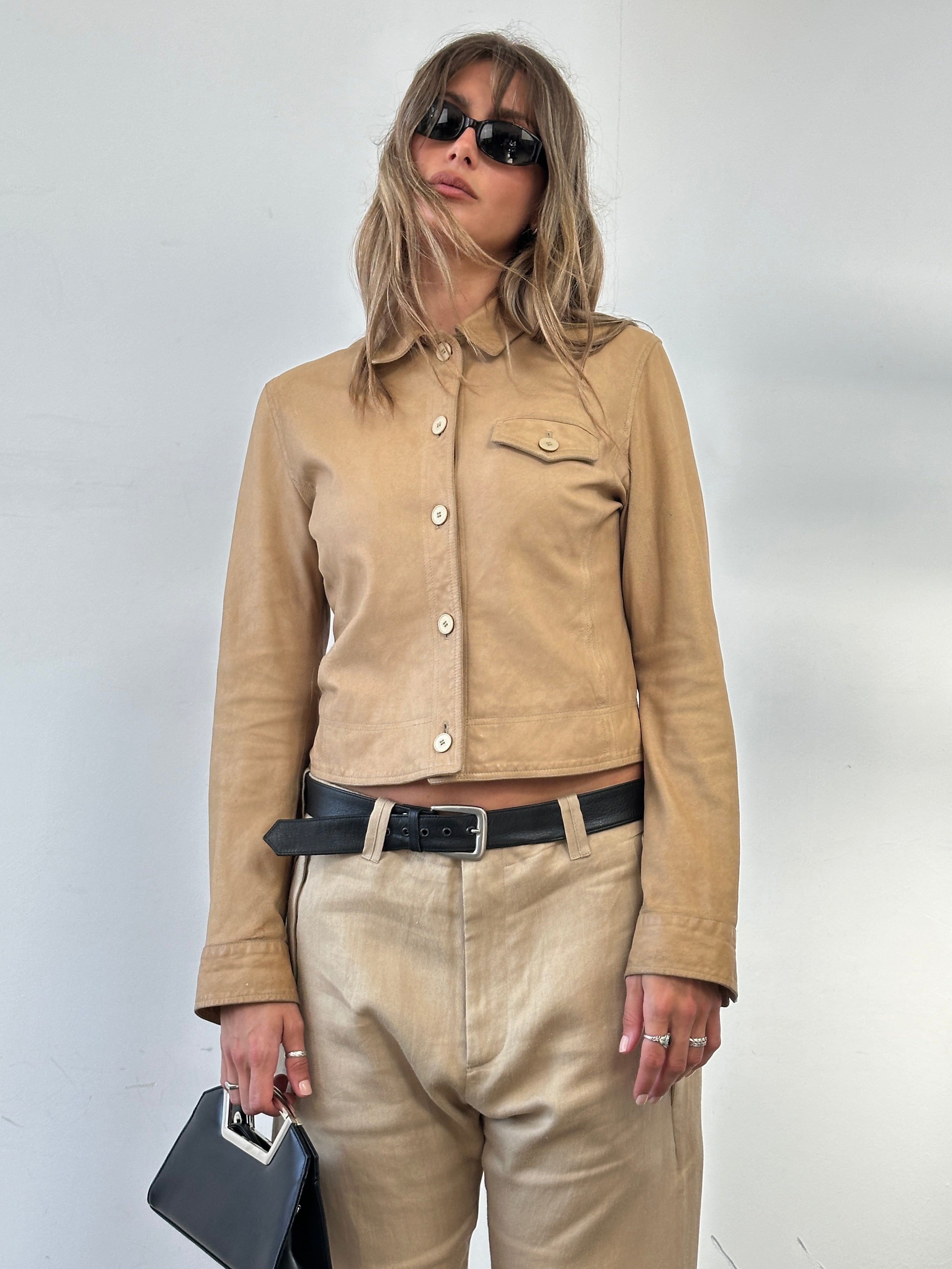 Armani Jeans fitted leather jacket from the circa 2000s, in black, shown on a hanger with visible stitching and classic design details.