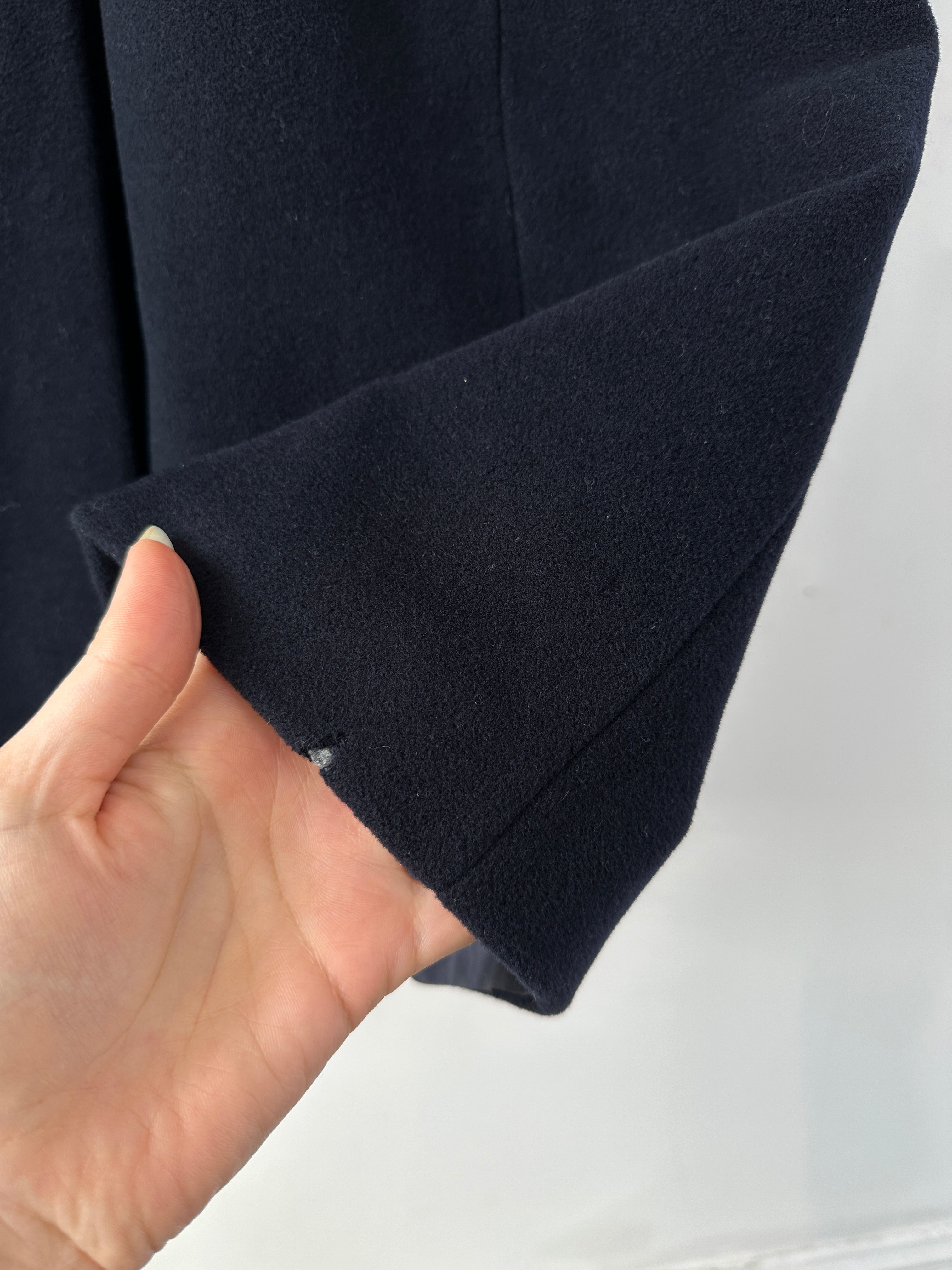 Emporio Armani pure wool single-breasted coat in black, tailored with lapel collar and button closure, displayed on a hanger.