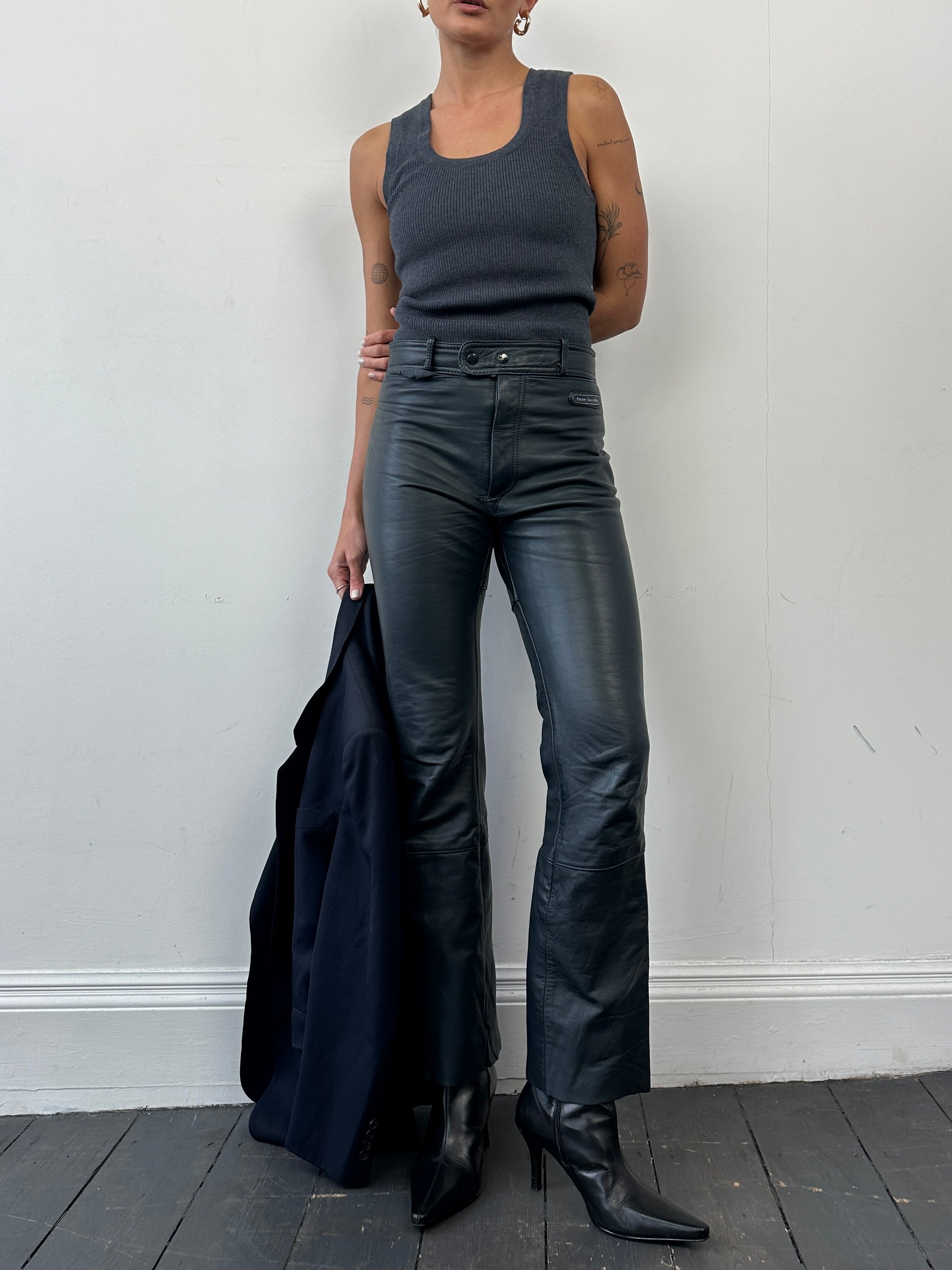 Vintage leather straight leg trousers in W28, showing classic design and rich texture on a neutral background.