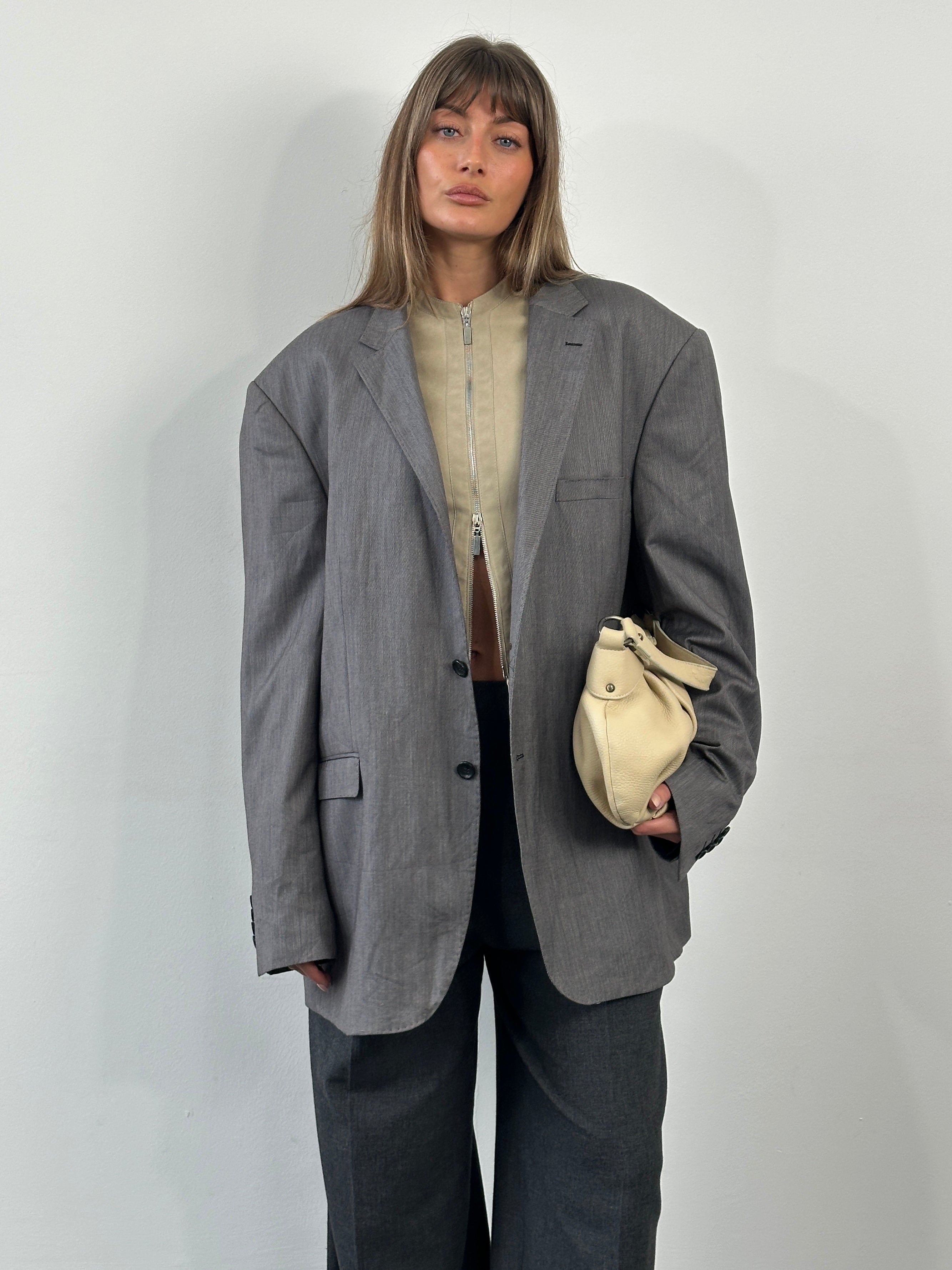 Loro Piana Doremen 1990s wool single-breasted blazer in size 50R/XXL, shown hanging on a wooden hanger.
