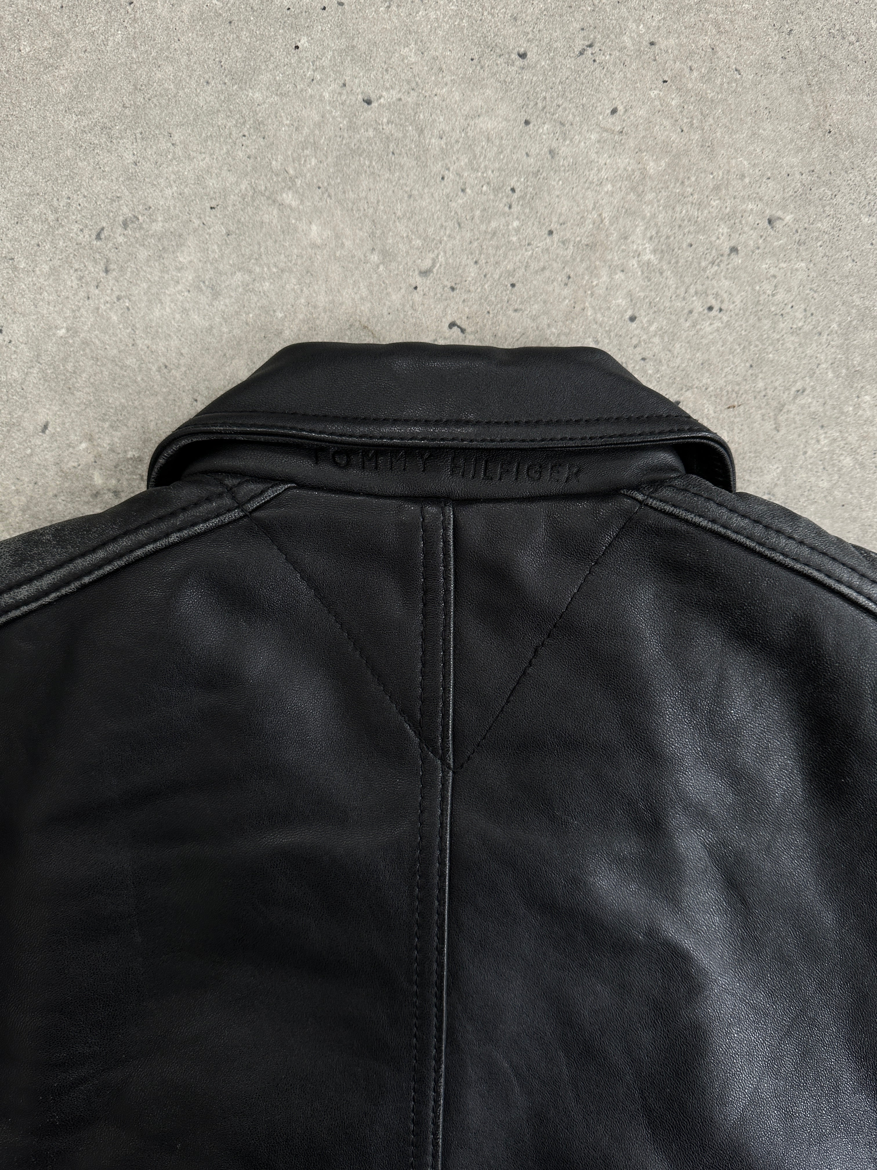 Tommy Hilfiger distressed leather bomber jacket in size M, featuring a stylish design with a worn-in leather look.