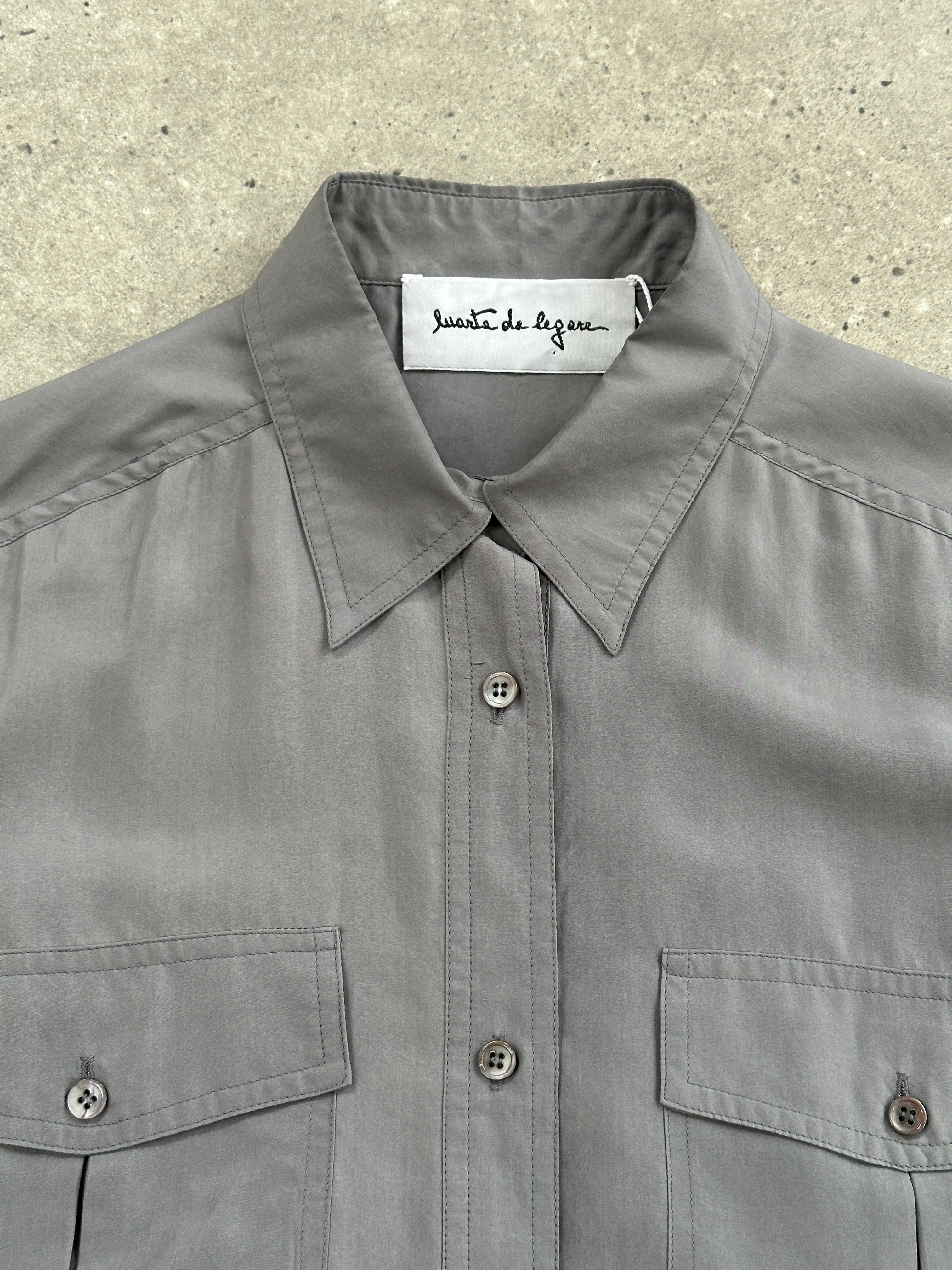 Vintage 1990s relaxed pure silk shirt in size L, featuring a classic design and soft fabric, displayed on a hanger.