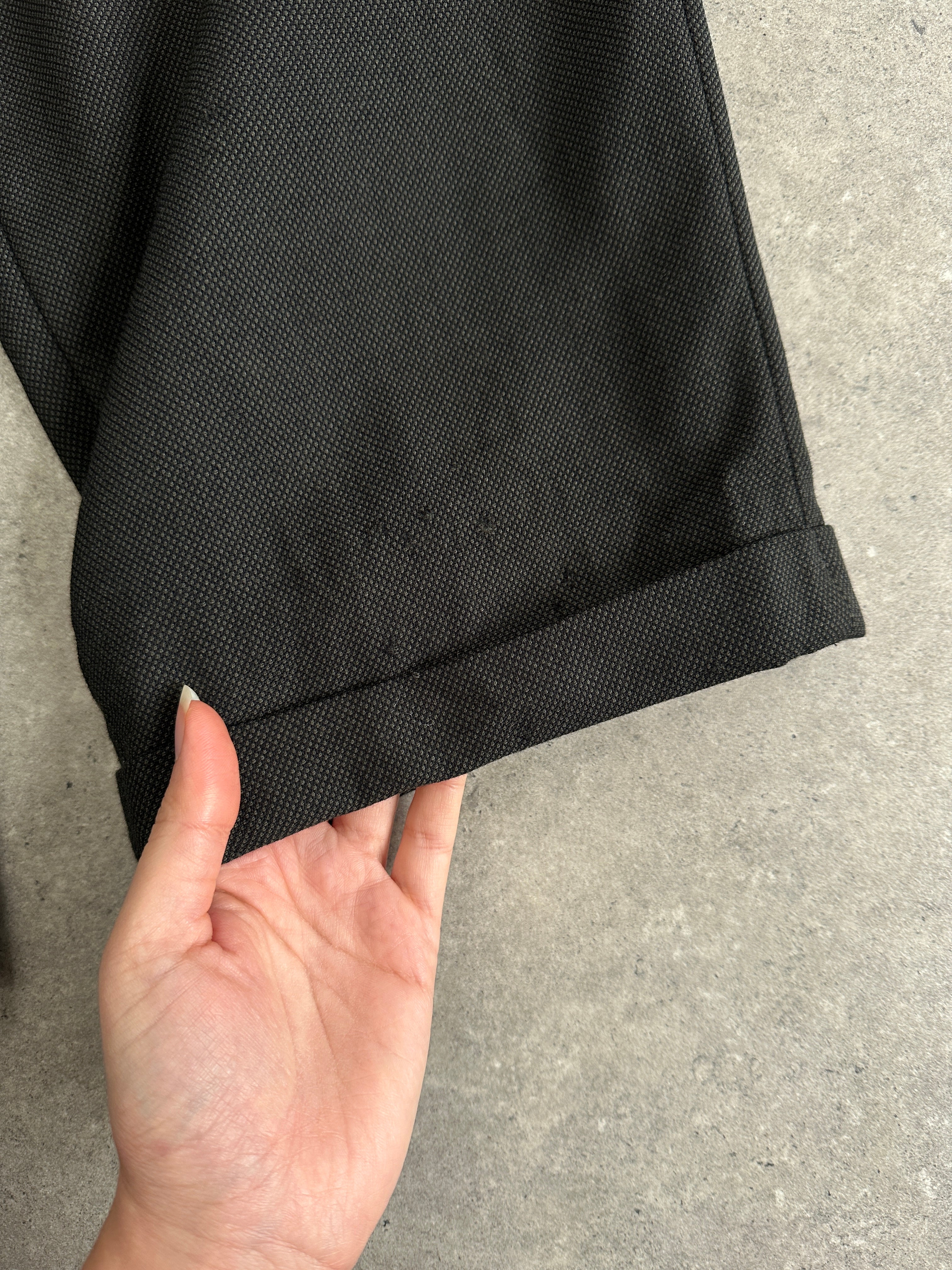 Christian Dior Monsieur wool tailored trousers in straight-leg fit, showing the classic design and fabric texture.