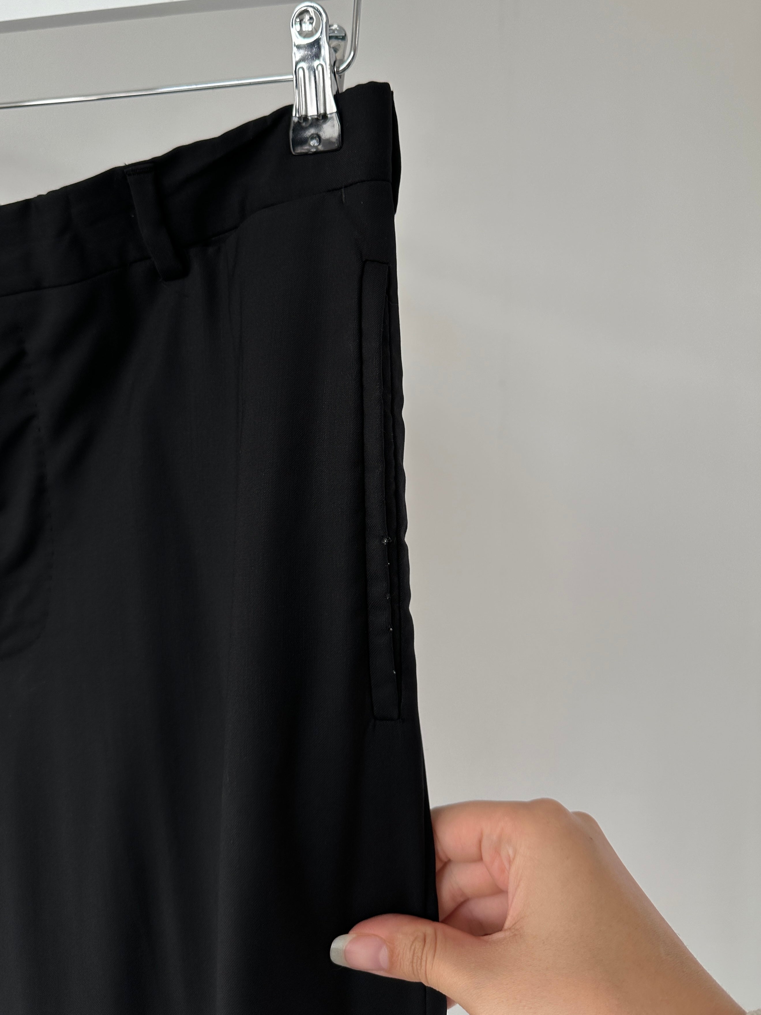 Prada virgin wool jumpsuit with mid-rise waist, single-breasted design, in size 40L/W28, displayed on a hanger.