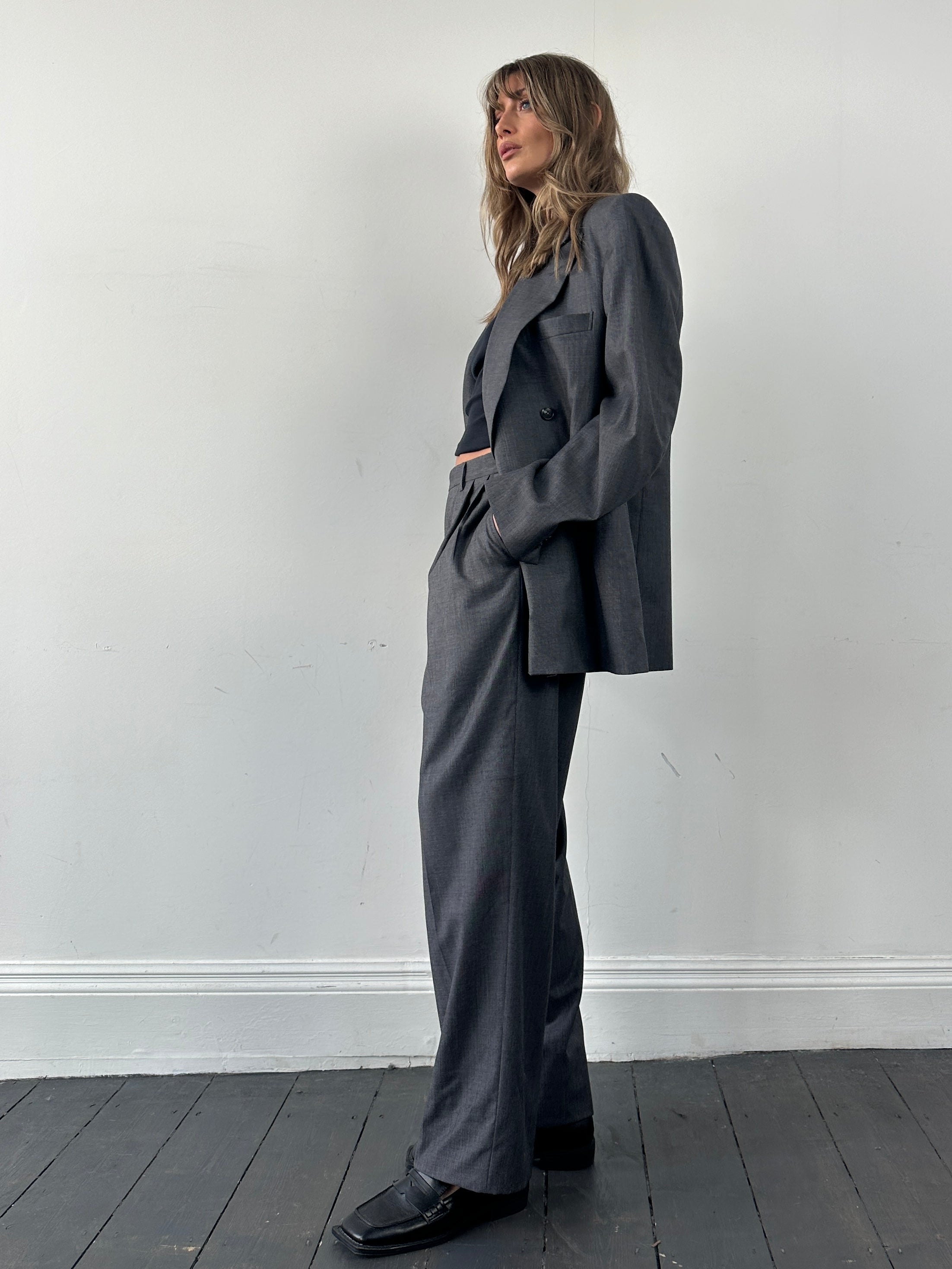 Christian Dior pure wool double-breasted jumpsuit in size 44S/W34, stylish tailored garment with lapel collar and button details.