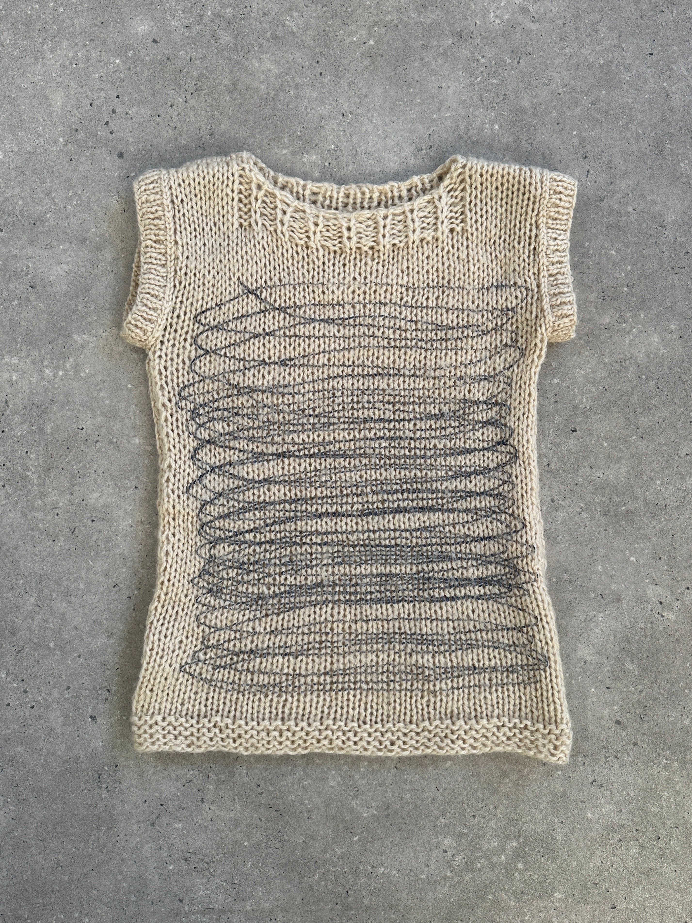 Vintage 1980s abstract wool knitted jumper sweater, medium size, featuring colorful geometric patterns on a cozy knit fabric.