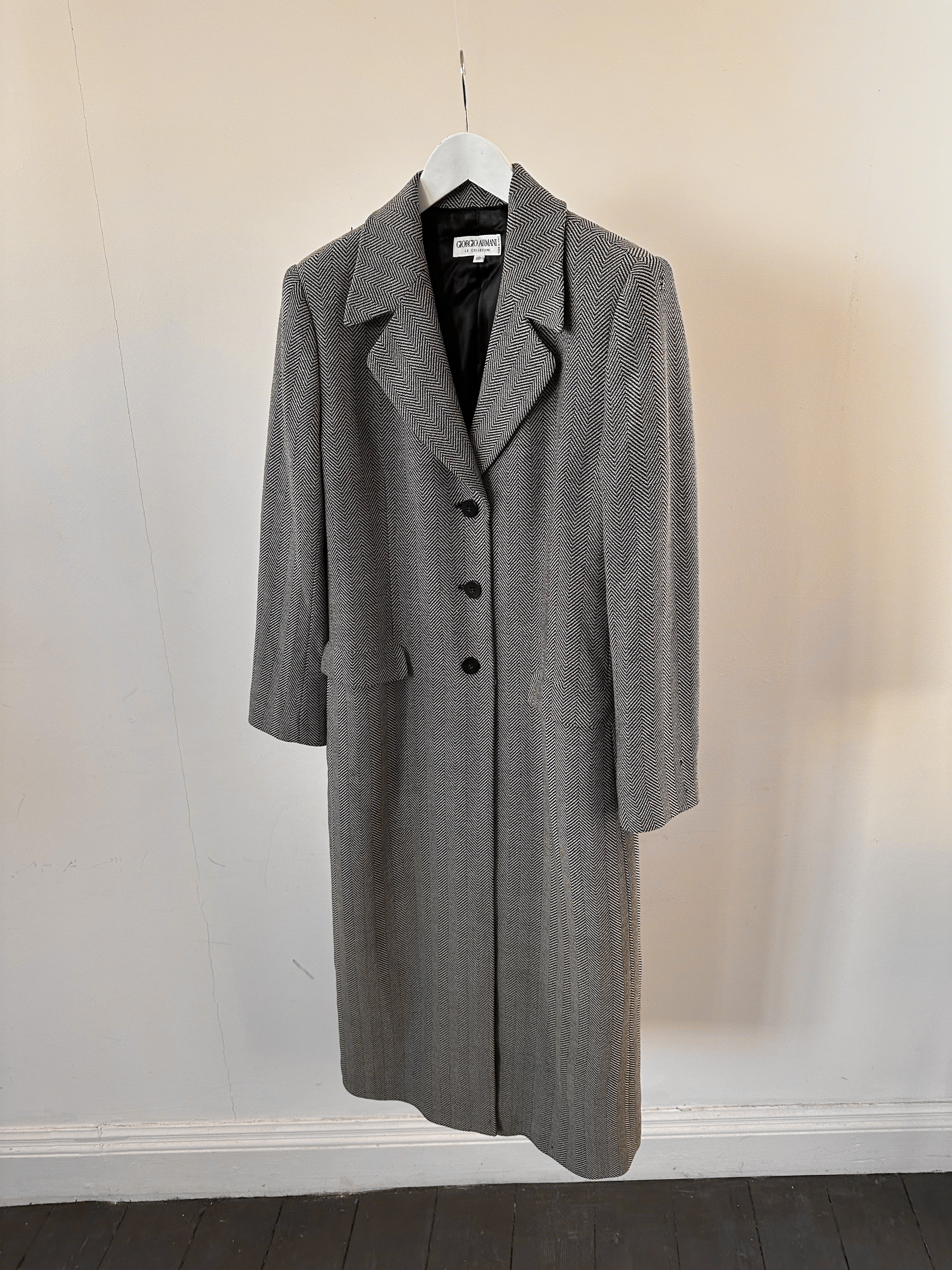Giorgio Armani Le Collezioni navy virgin wool herringbone coat with classic tailored fit, displayed on a hanger.