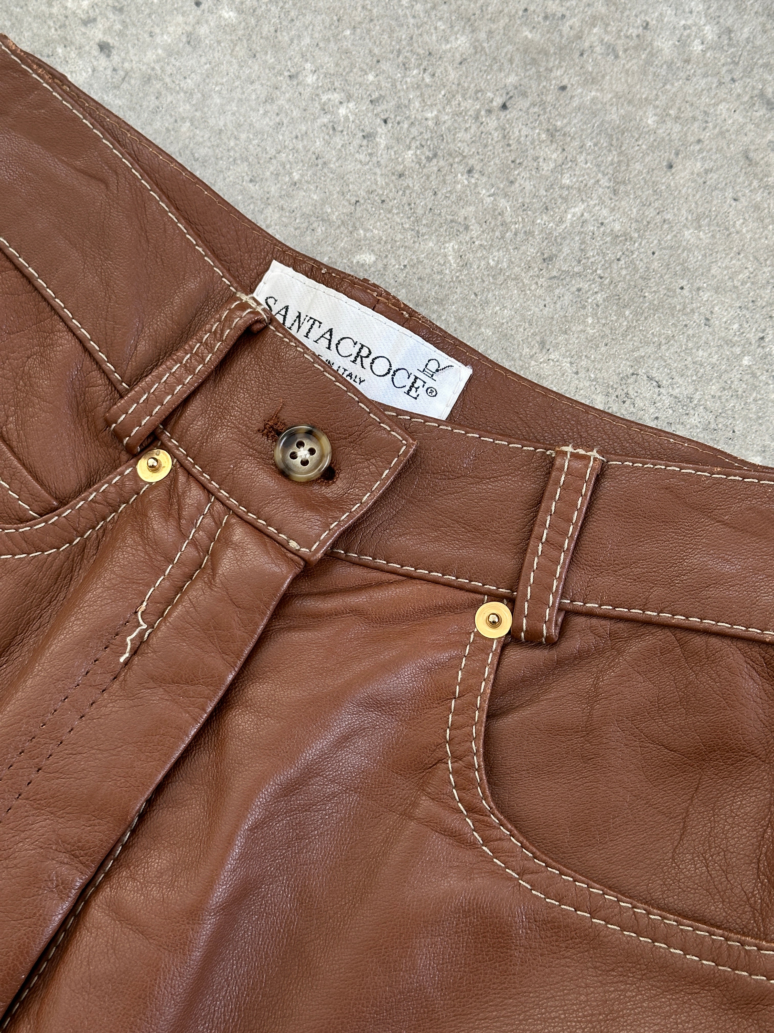 Vintage Italian high waisted leather trousers with tapered legs, featuring a vintage style and tailored fit.