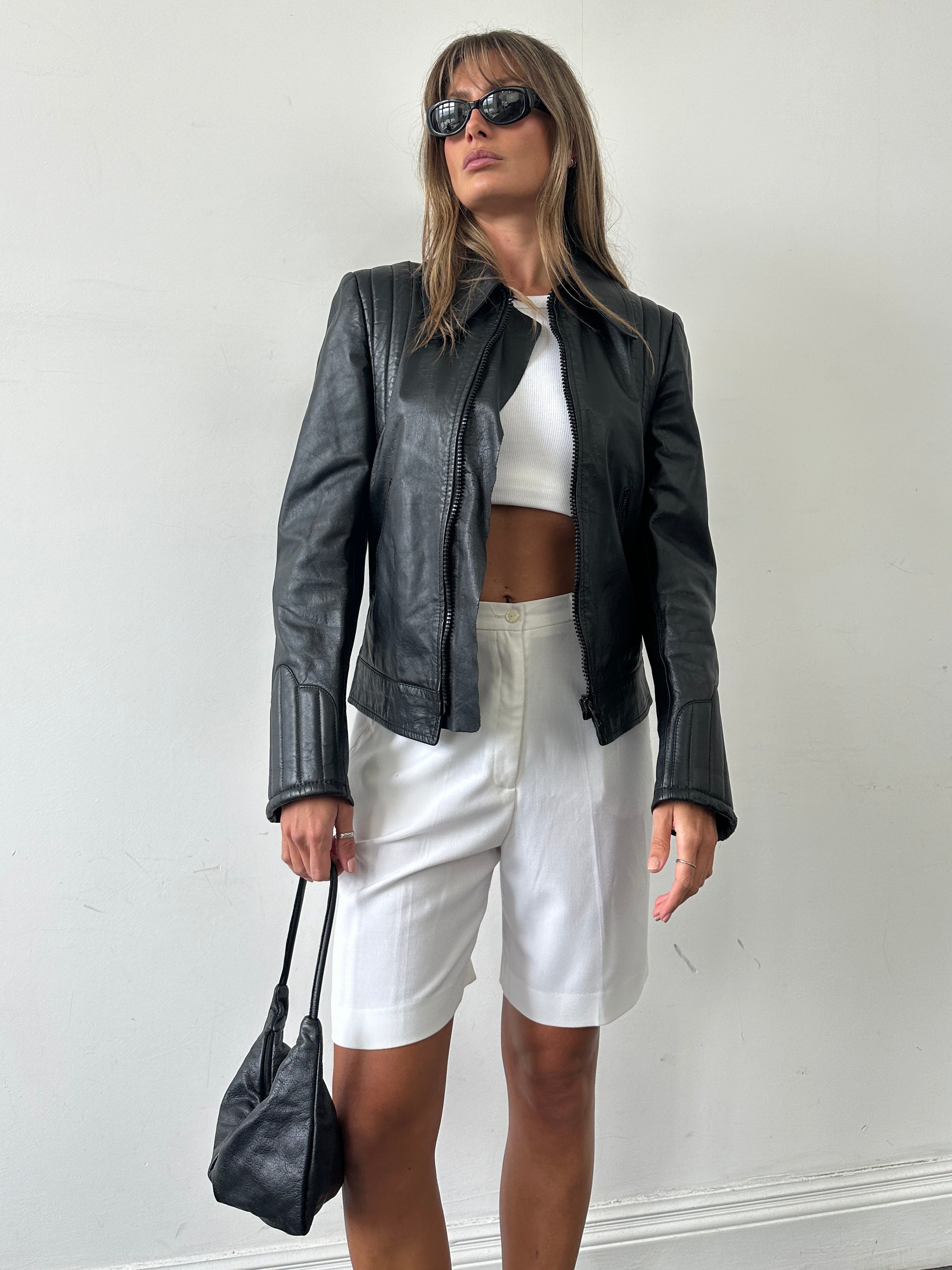 Italian vintage quilted leather jacket in XS by Vintage, showing the textured brown leather with quilted detailing and classic collar.
