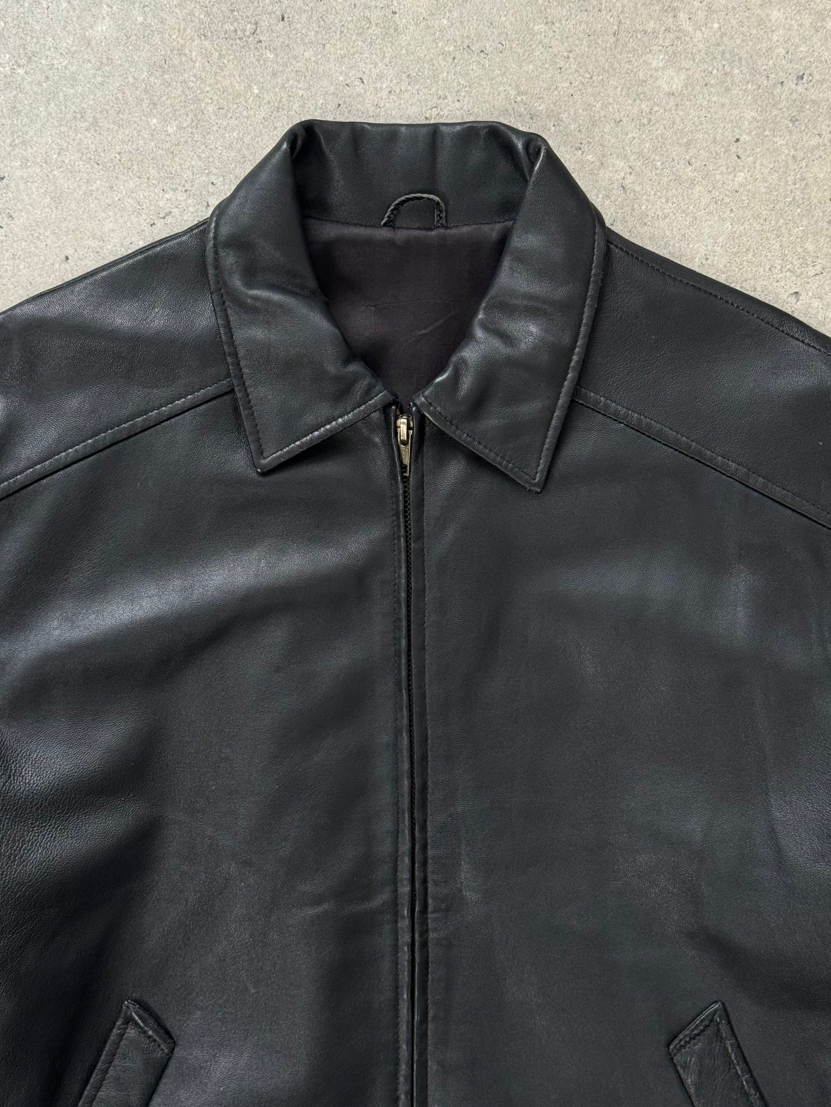 Vintage 1990s leather bomber jacket in size S/M, featuring classic design and aged leather texture.
