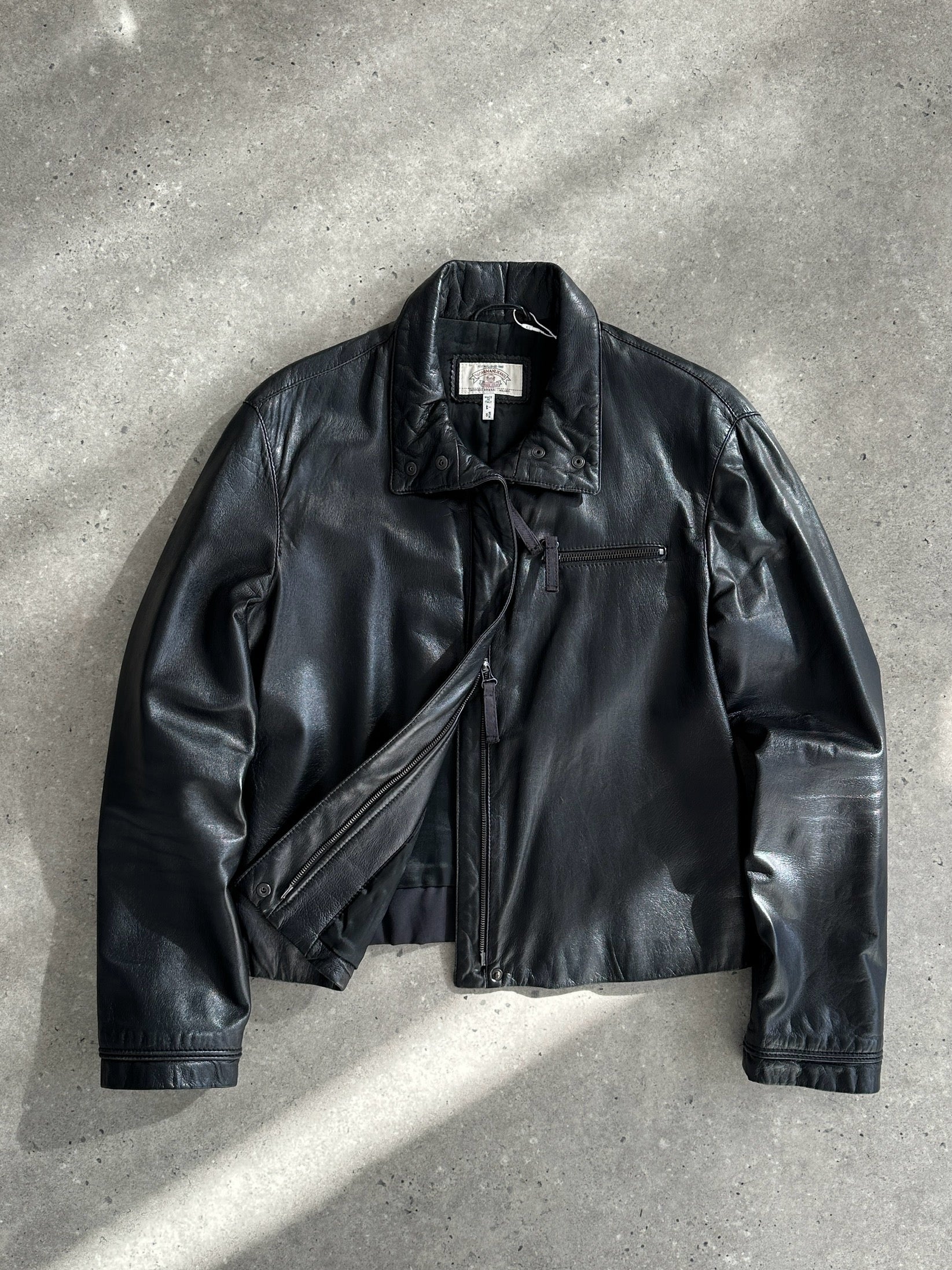 Armani Jeans double zip leather jacket in black, featuring silver zippers and a fitted style, displayed on a hanger.