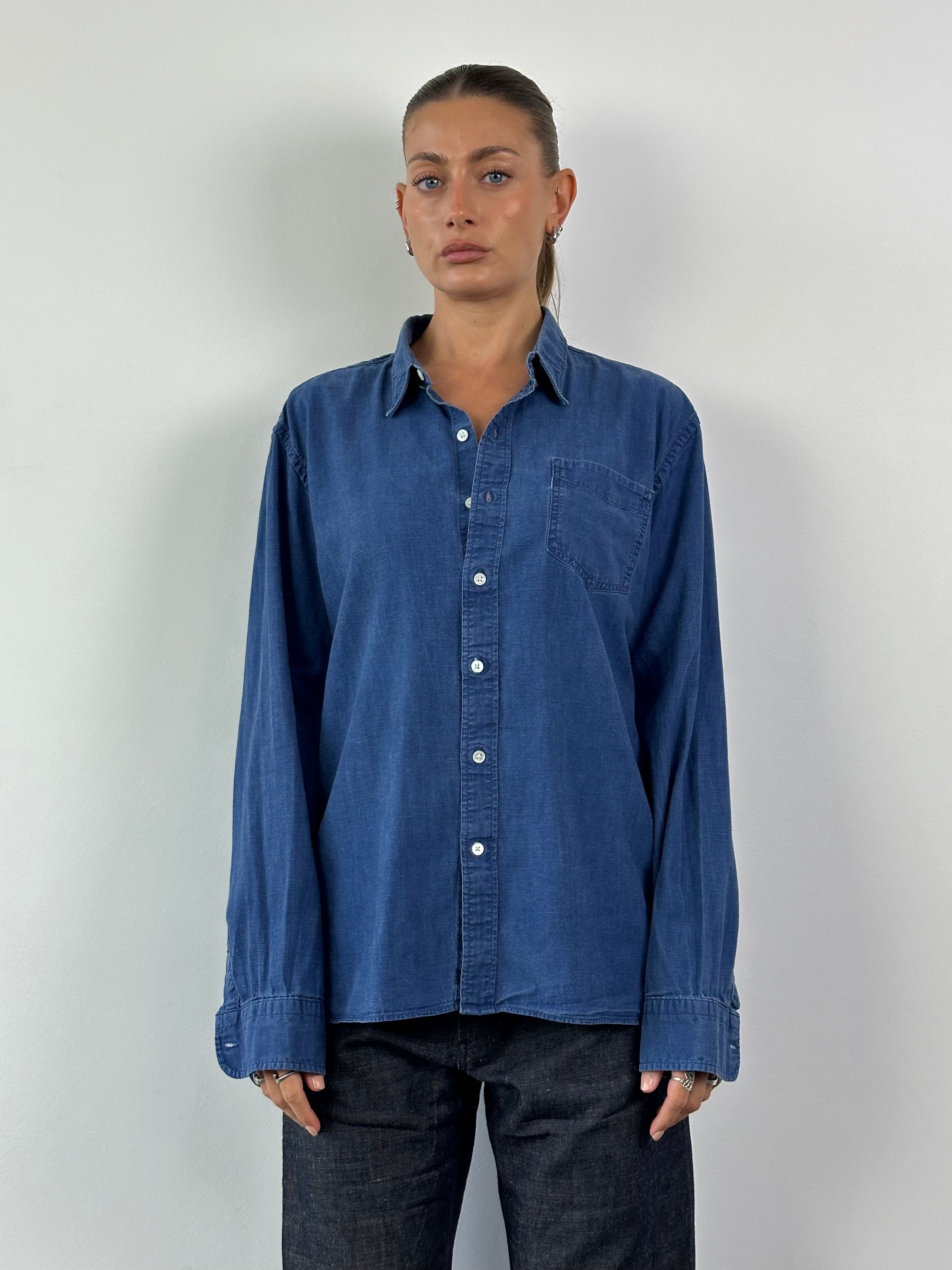 Levi’s pure cotton denim shirt in XL, featuring a classic button-up design, shown on a neutral background.