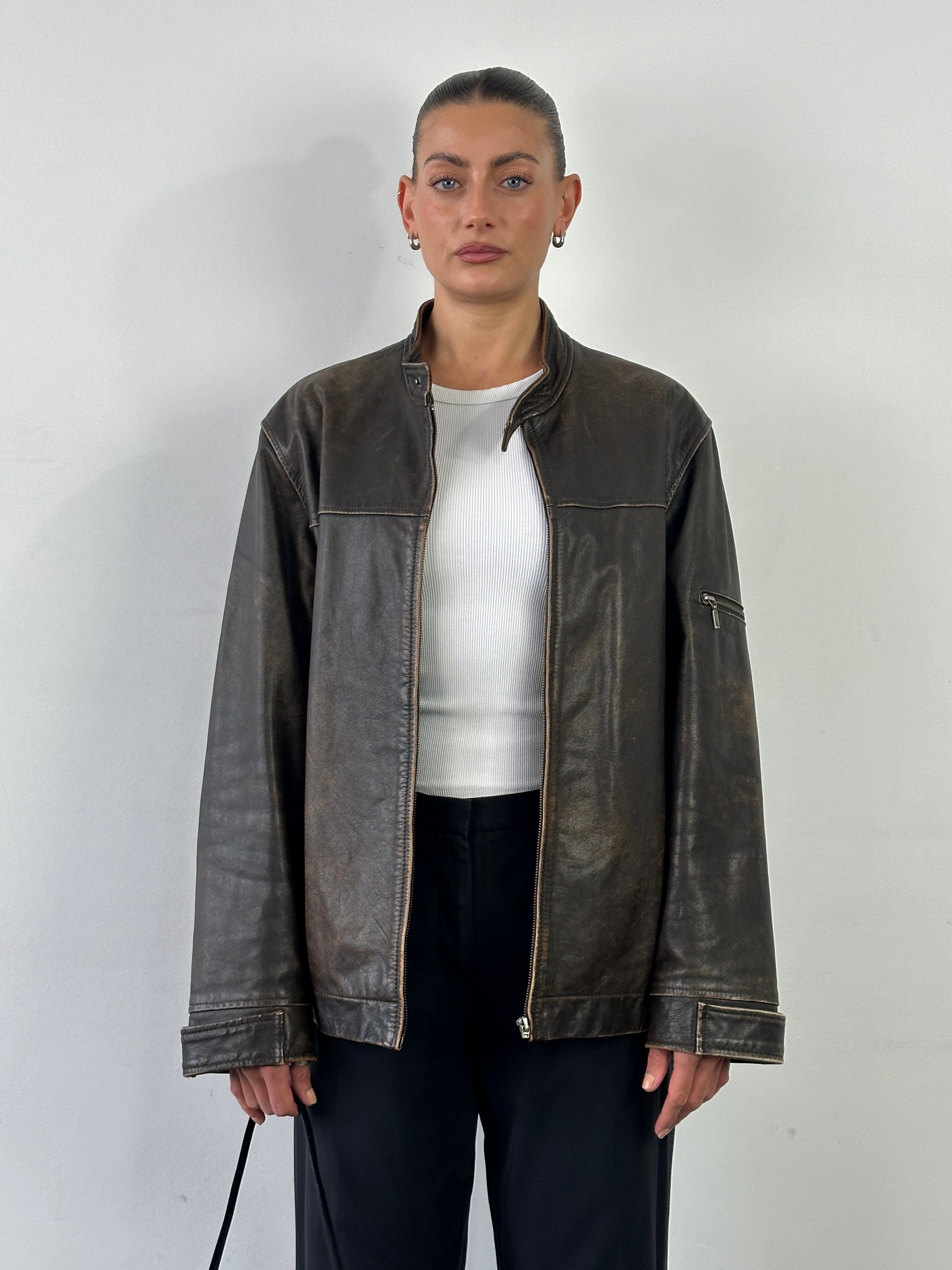 Vintage brand vintage leather motorcycle jacket in aged brown leather, size large, with classic design and detailed stitching.