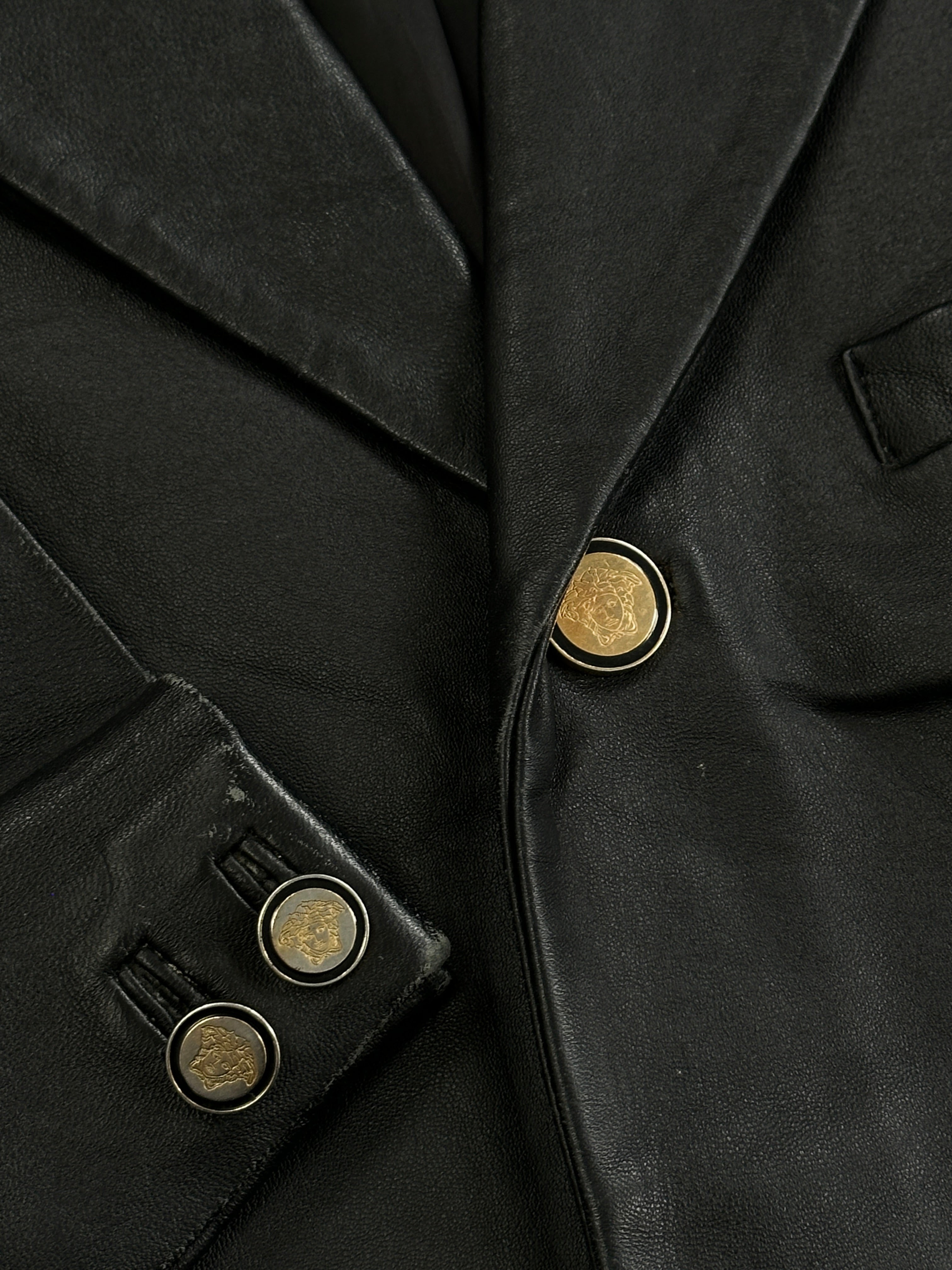 Versace Jeans Couture bespoke leather blazer jacket in size XL, stylish black leather with tailored fit and button details.