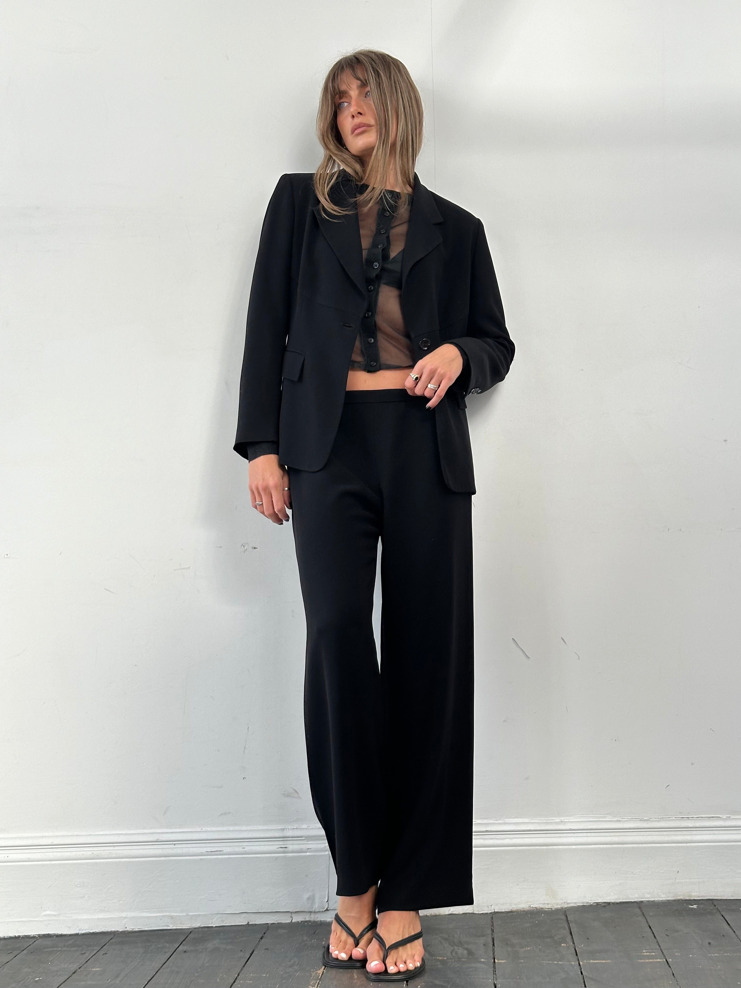Max Mara minimal single-breasted jumpsuit in black, tailored fit, with lapel collar and sleek design, suitable for formal or casual wear.