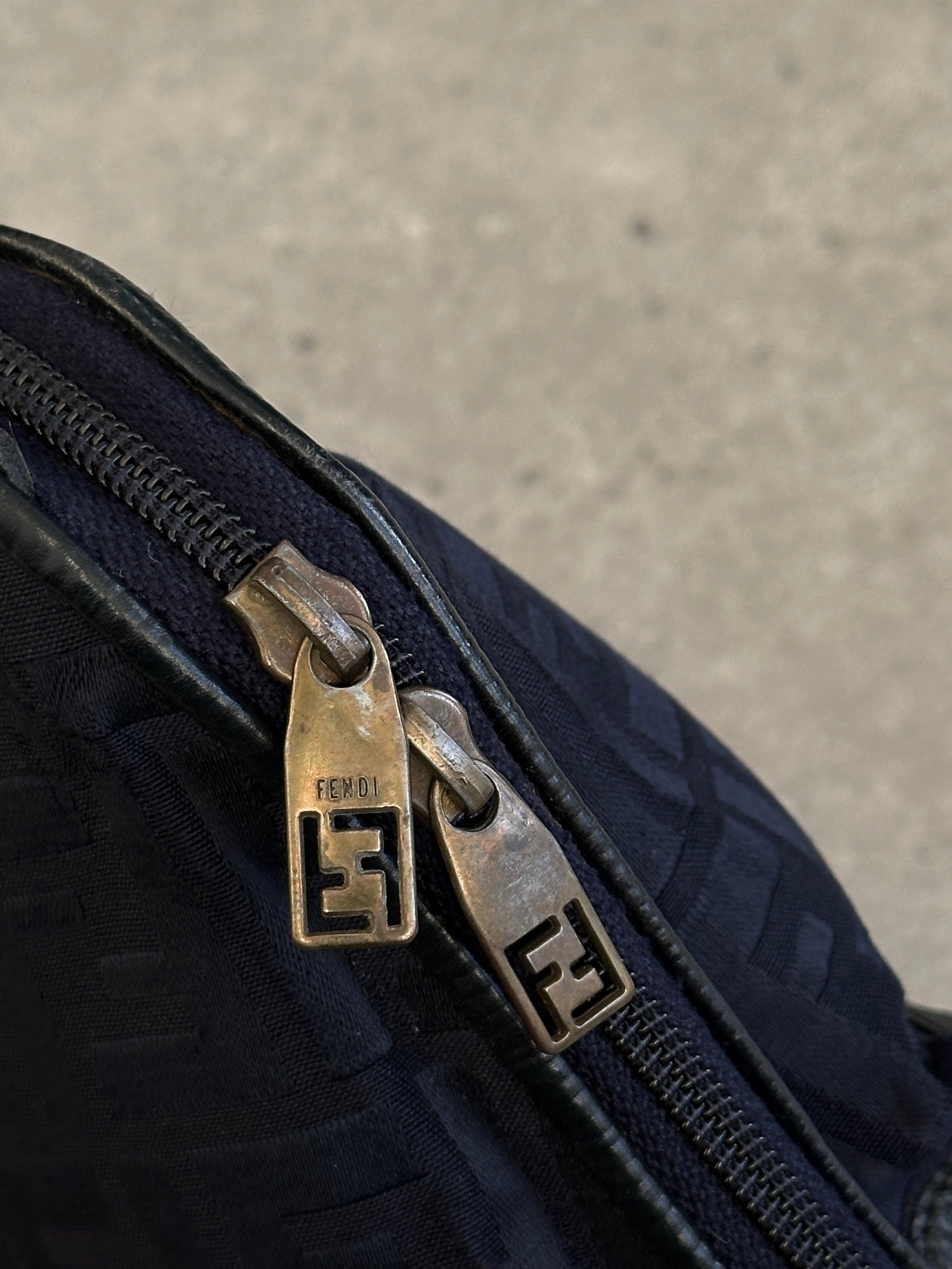 Fendi FF Monogram crossbody bag with adjustable strap, featuring signature logo pattern and sleek design.