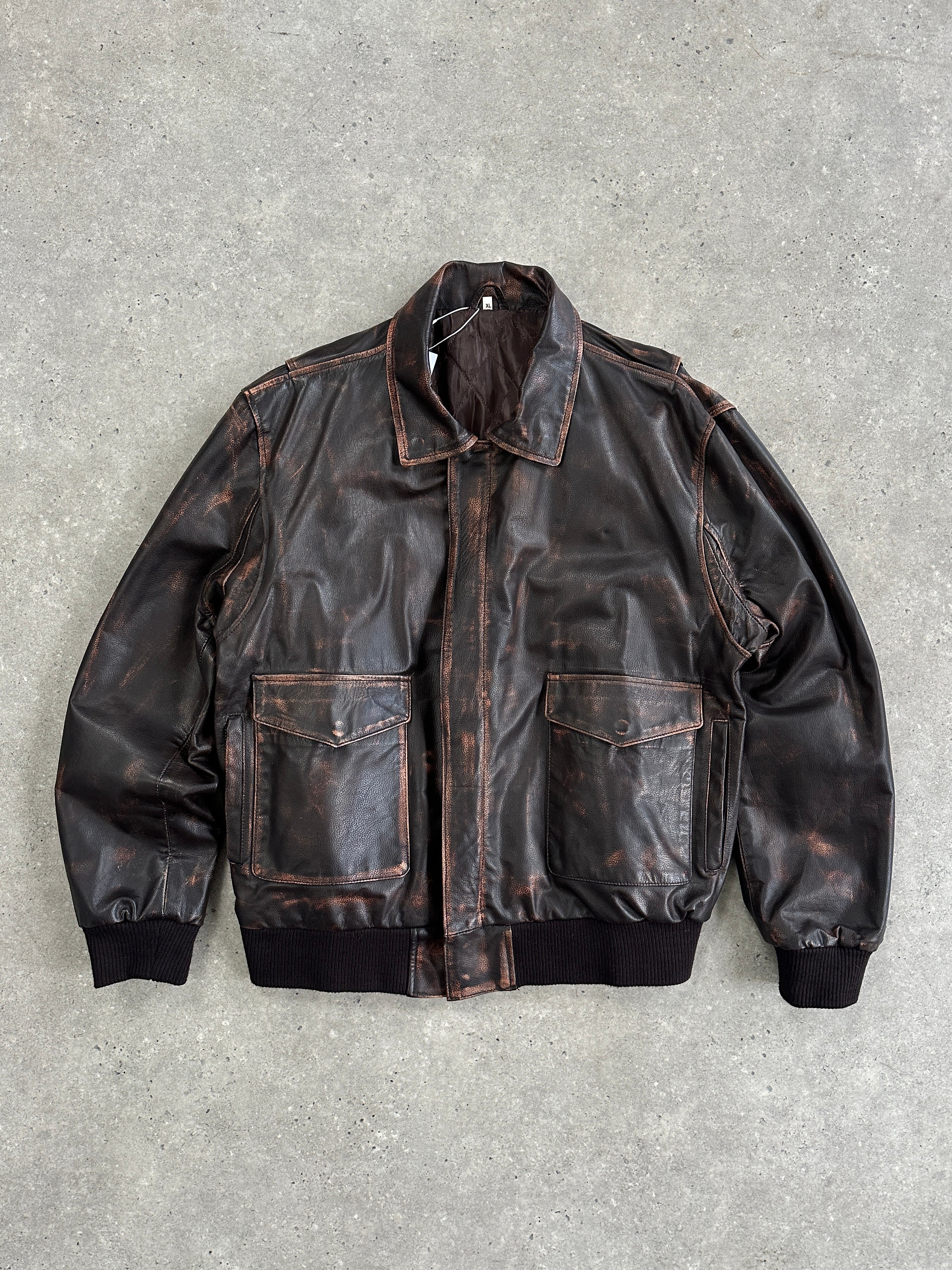 Vintage distressed leather jacket in size XL, featuring a rugged, worn-in look with classic style and detailed stitching.