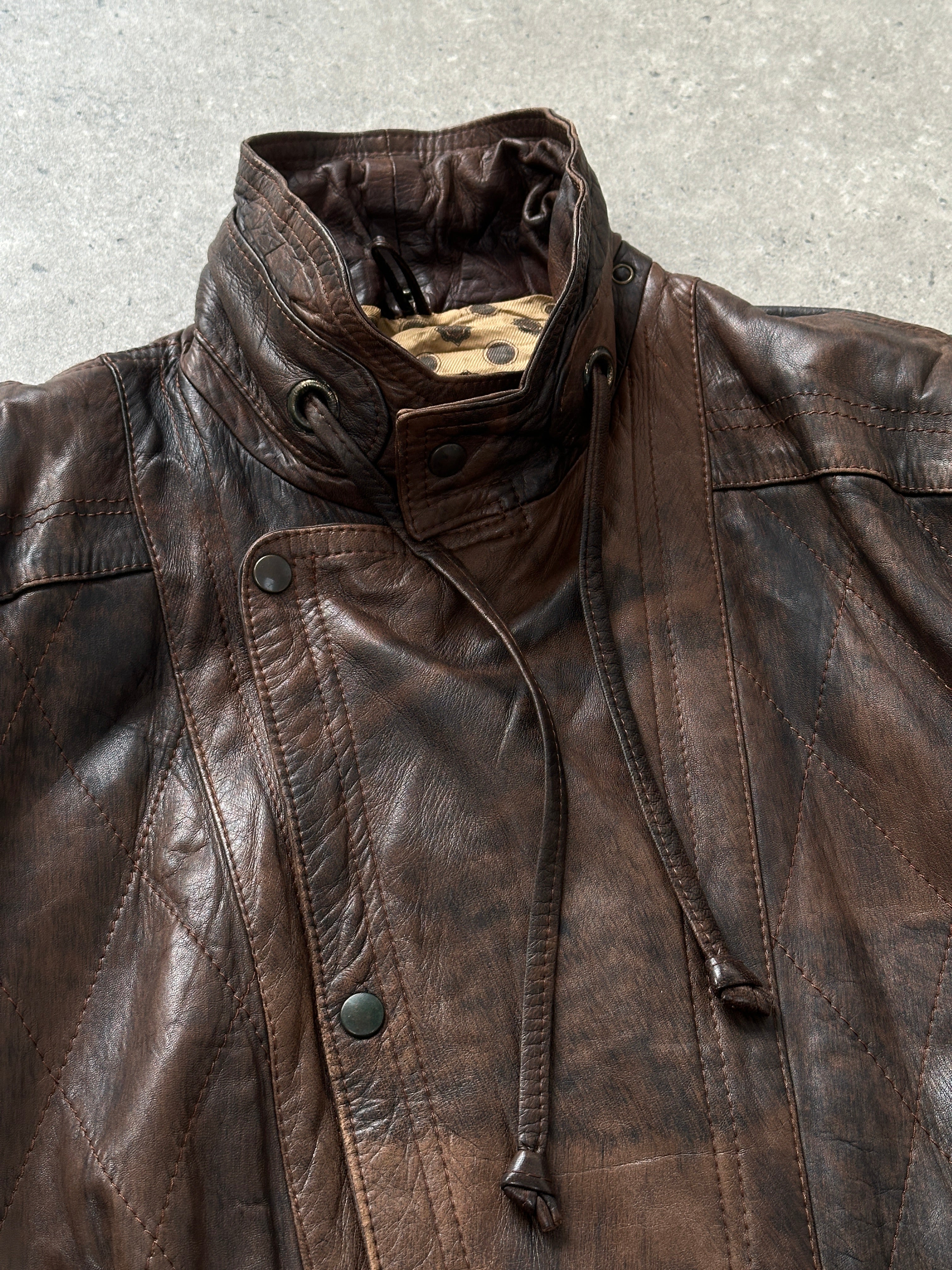Vintage 1990s high neck aged leather bomber jacket in XL size, featuring distressed leather and classic bomber style.