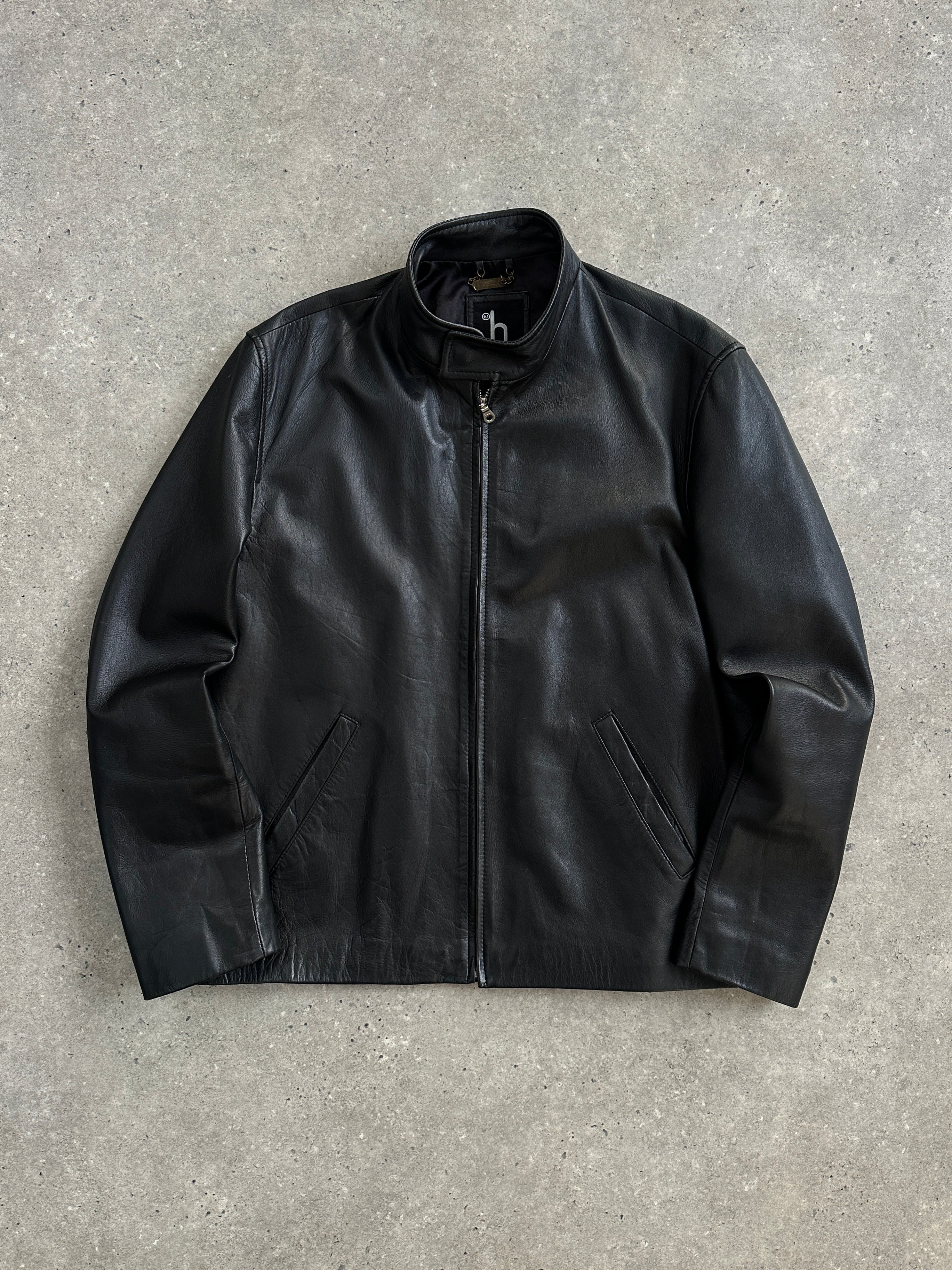 Vintage 2000s minimal high neck leather jacket in black, showing the sleek design and high collar on a mannequin.