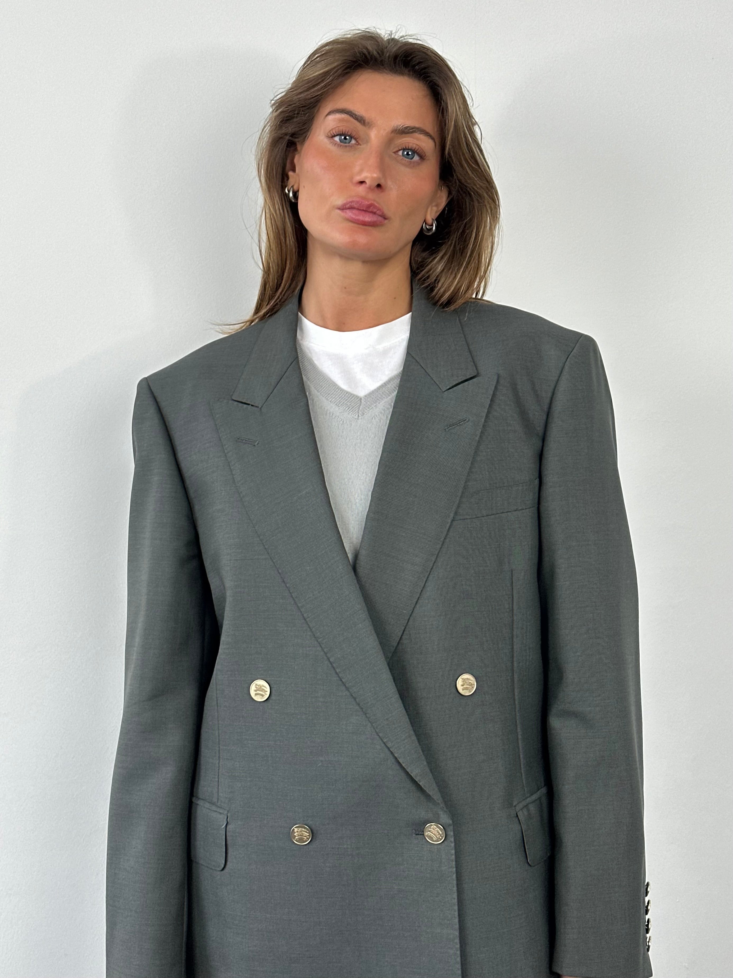 Burberry 1990s wool and mohair double-breasted blazer in XL, shown on a hanger with classic check lining visible inside.