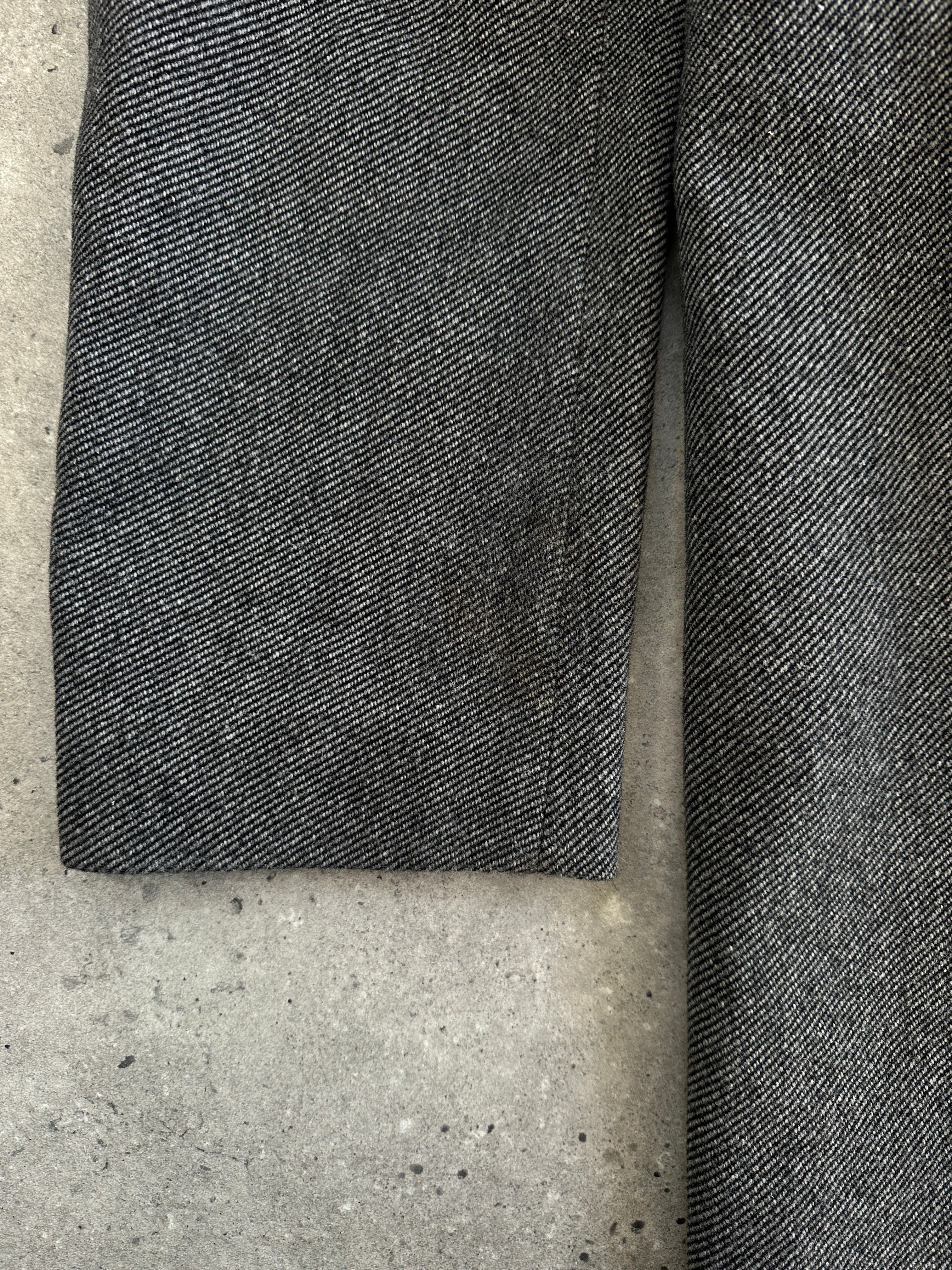 Hugo Boss 1990s wool single-breasted coat in XXL, dark color, featuring a classic collar and button closure, displayed on a hanger.