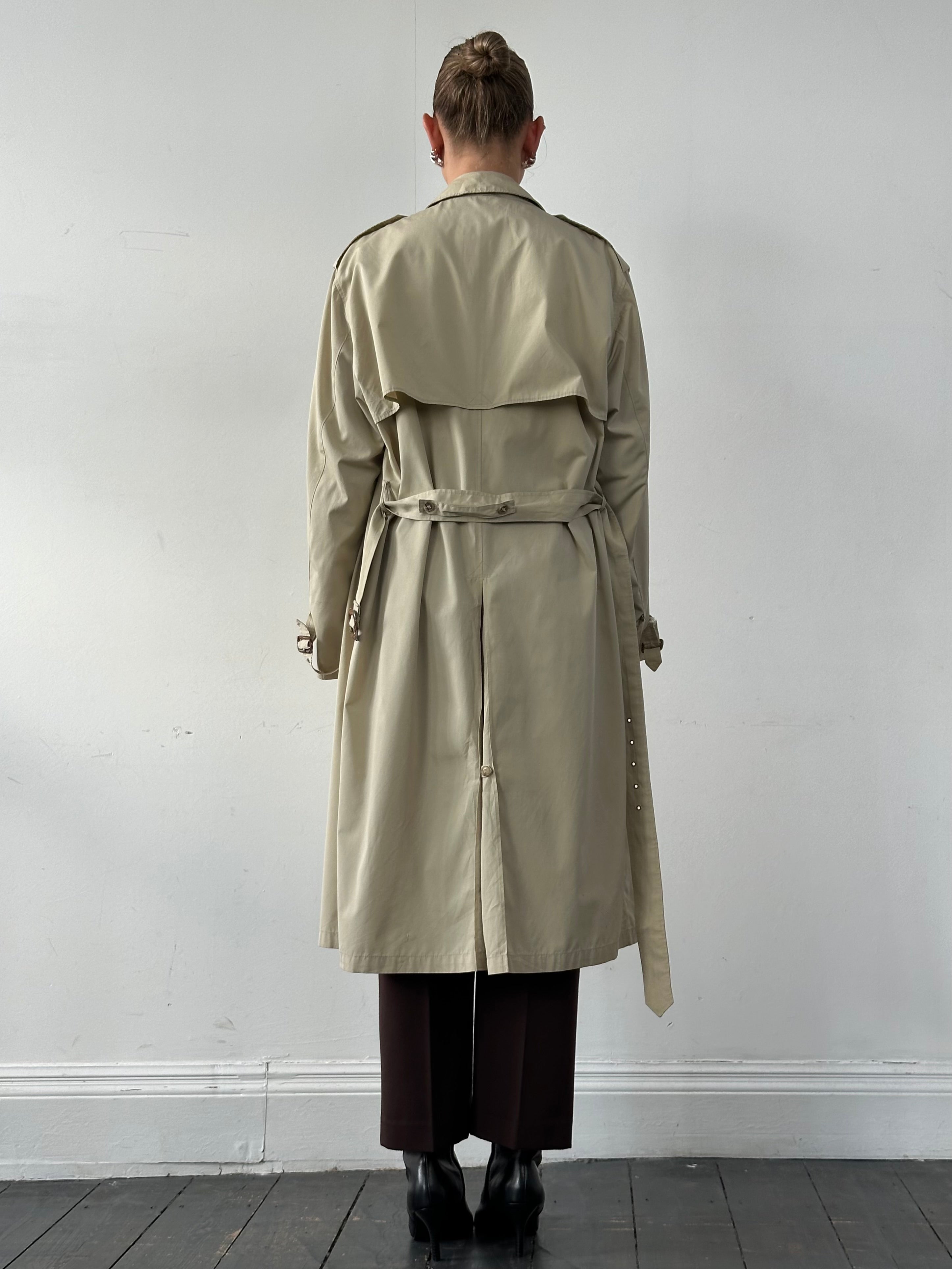 Christian Dior Paris cotton double-breasted belted trench coat in beige, shown on model with classic collar and button details.