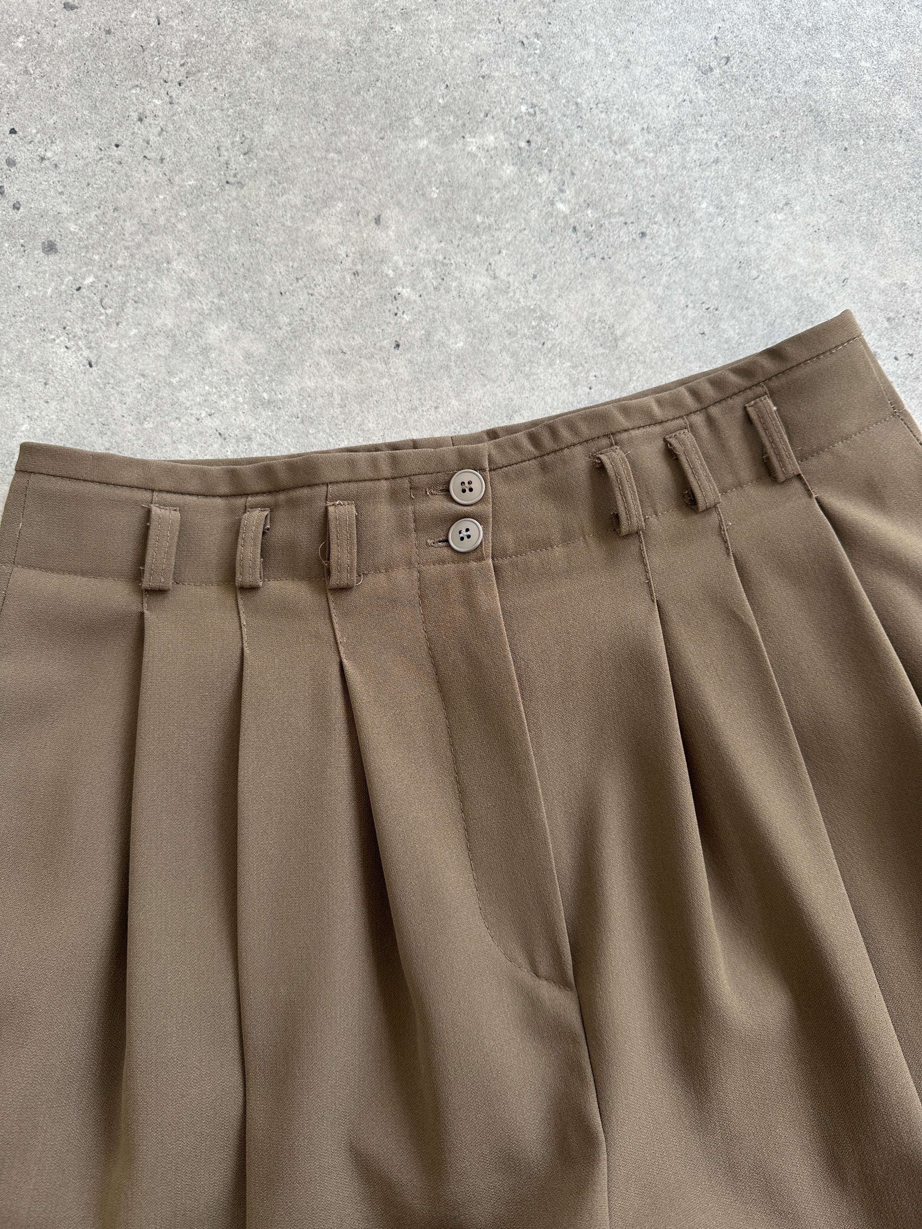 Vintage 1990s high-waisted pleated tailored trousers in size W28, showcasing classic vintage style and structured fit.