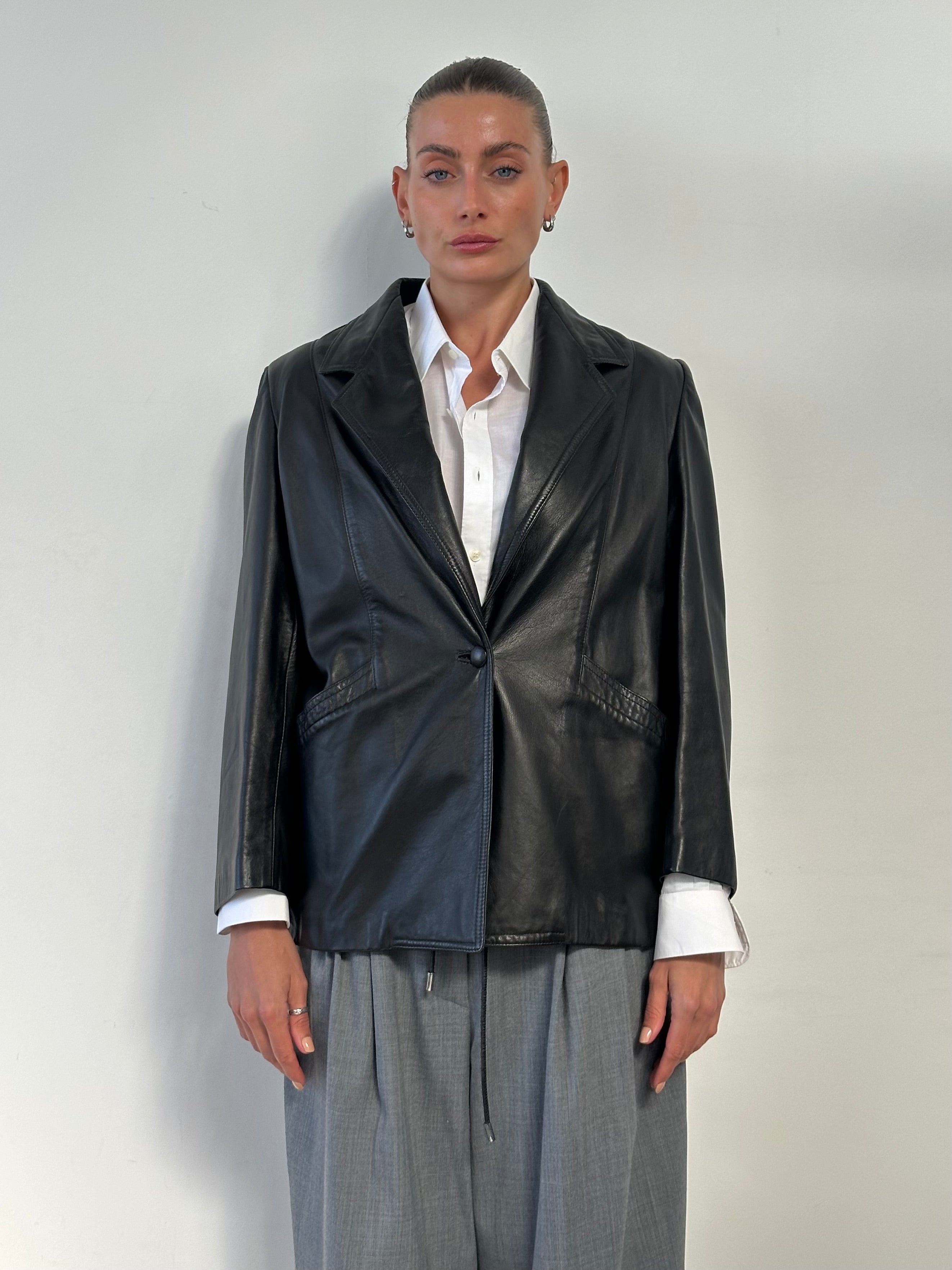 Vintage single button leather blazer jacket, men's size M, showcasing classic leather texture and tailored fit.