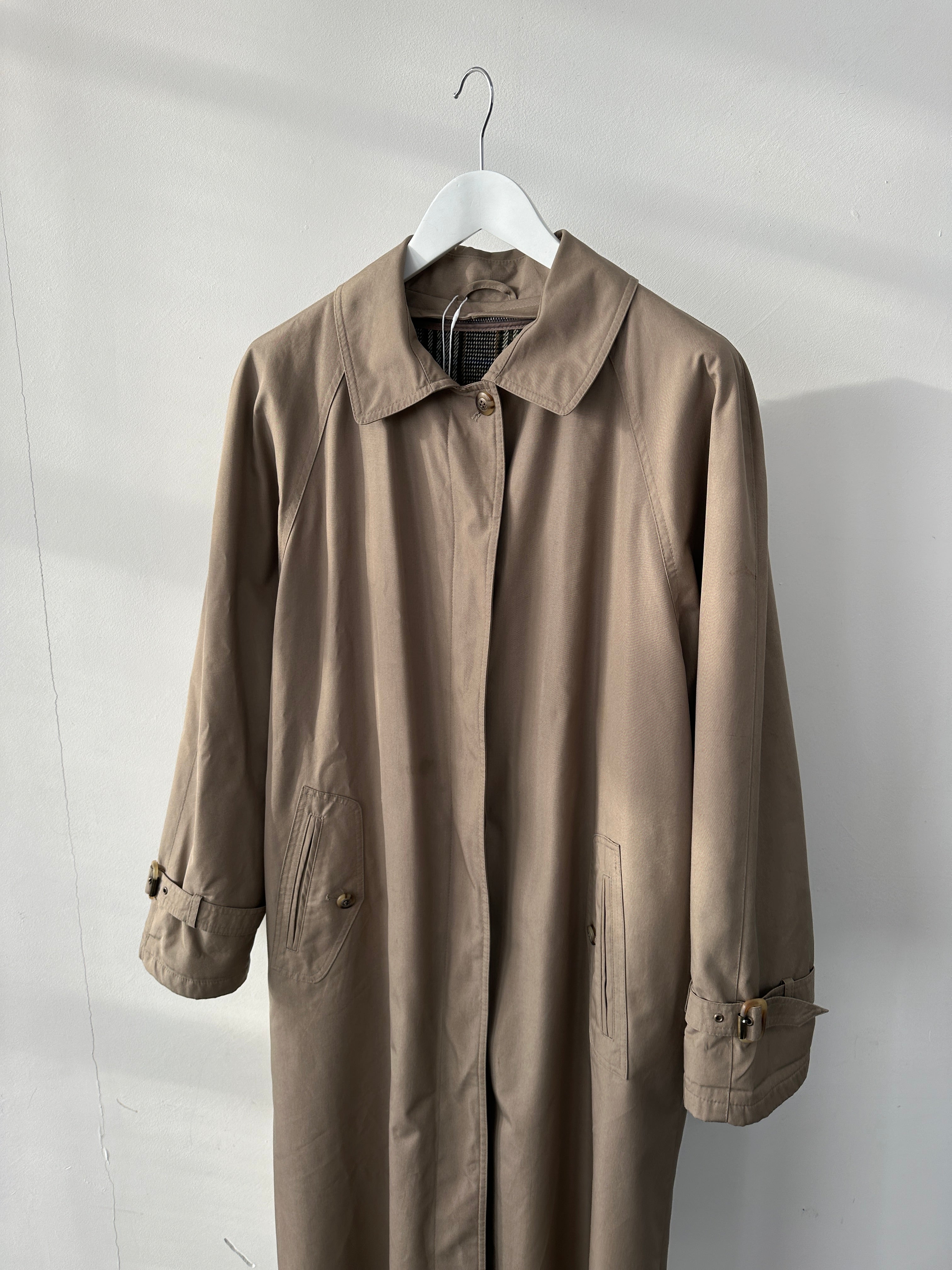 Vintage water-resistant trench coat with concealed placket, black, tailored fit, suitable for M/L sizes, stylish and functional outerwear.