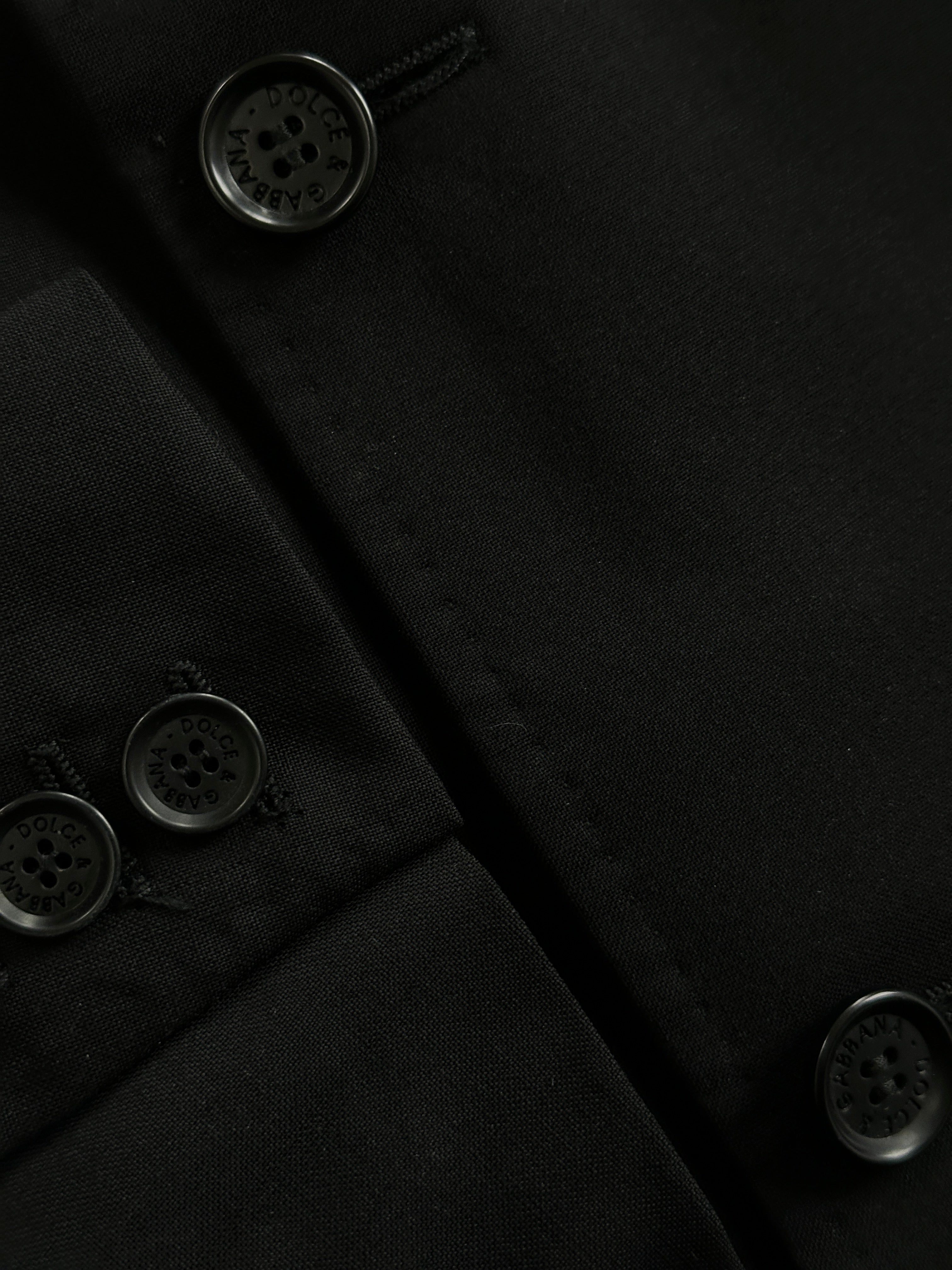 Dolce & Gabbana single-breasted virgin wool blazer in classic black, tailored fit with notch lapels and button closure.
