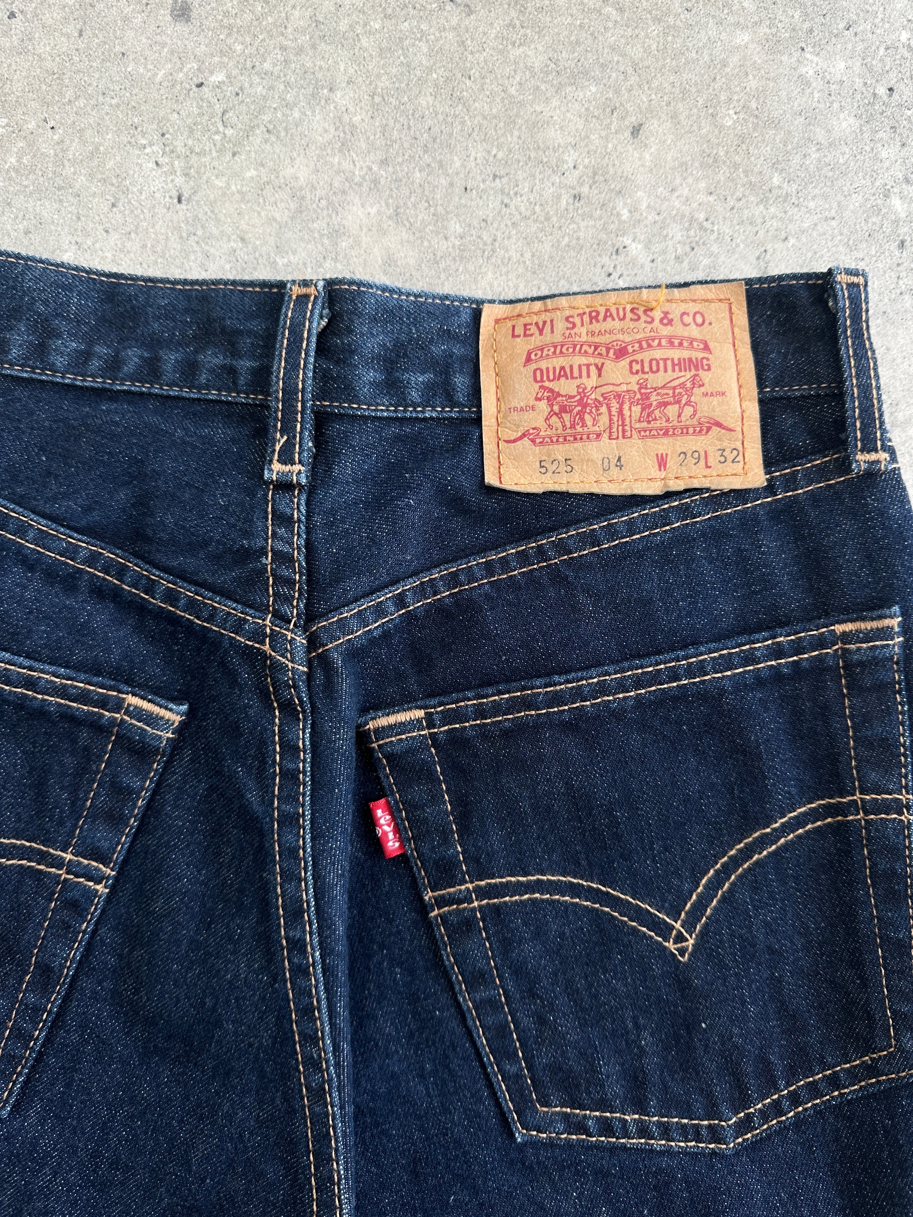 Levi’s 525 mid-rise denim bootcut jeans in W26, showing classic blue denim fabric and relaxed fit style.