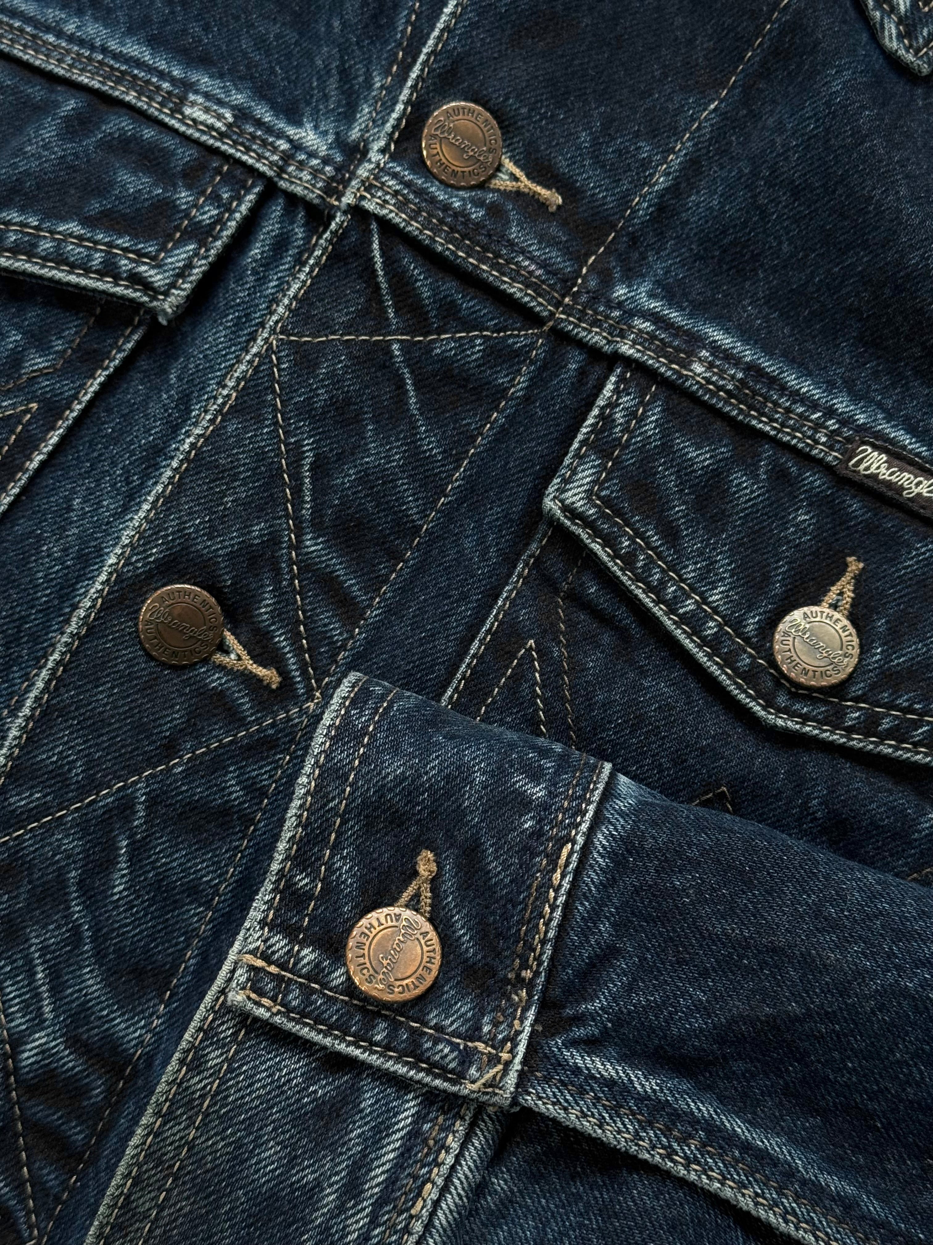 Wrangler 1990s mid wash denim jacket in XL displayed on a hanger, showcasing classic style and rugged denim fabric.