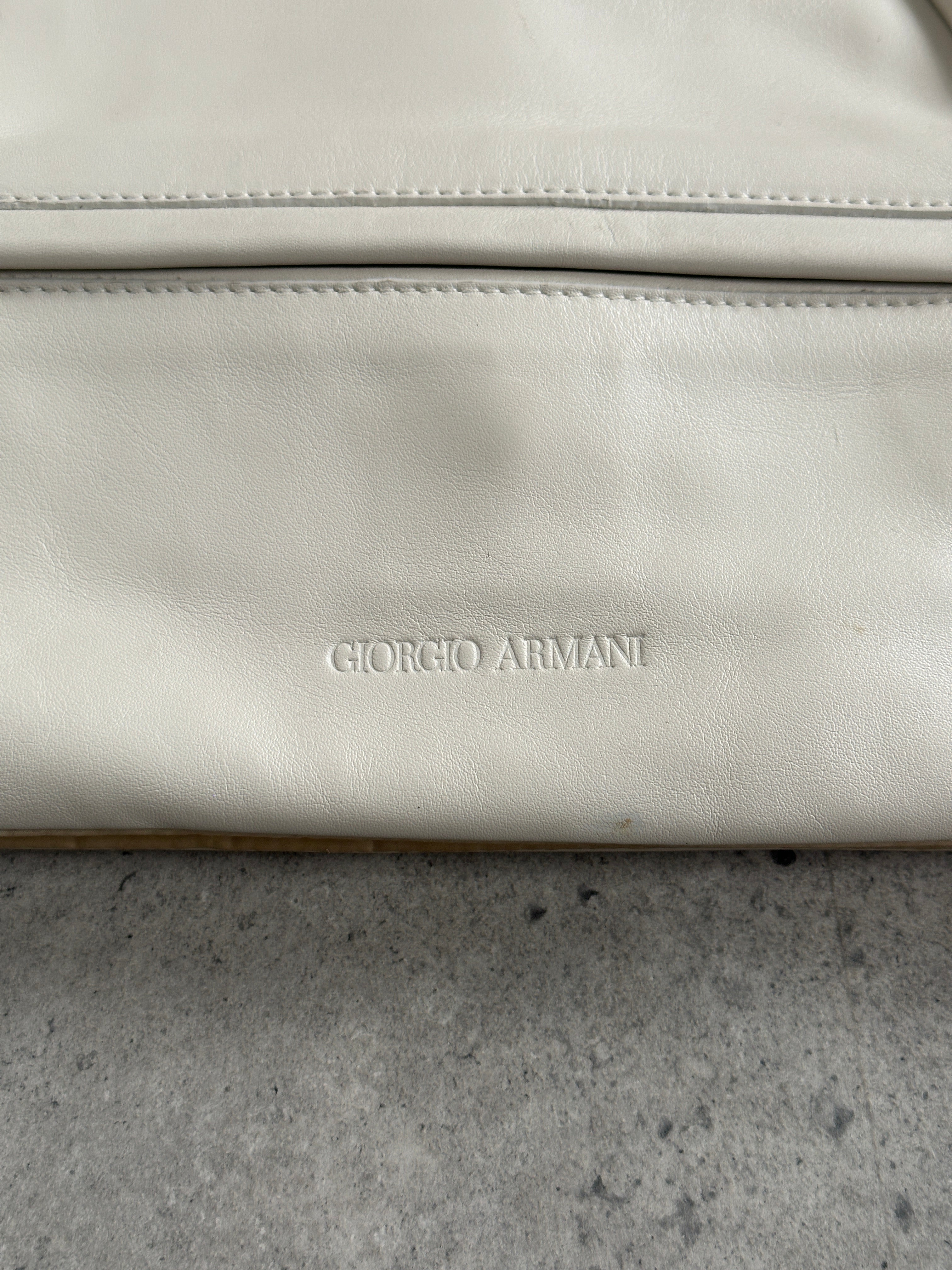 Giorgio Armani Le Collezioni embossed logo handbag with textured leather and top handle, stylish and elegant accessory.